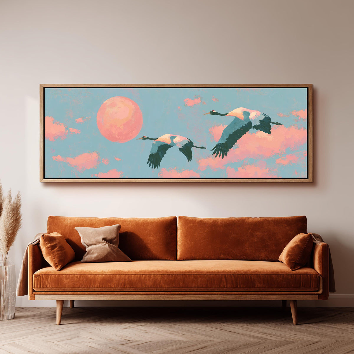 Two cranes flying at sunset panoramic canvas print above a sofa in a living room