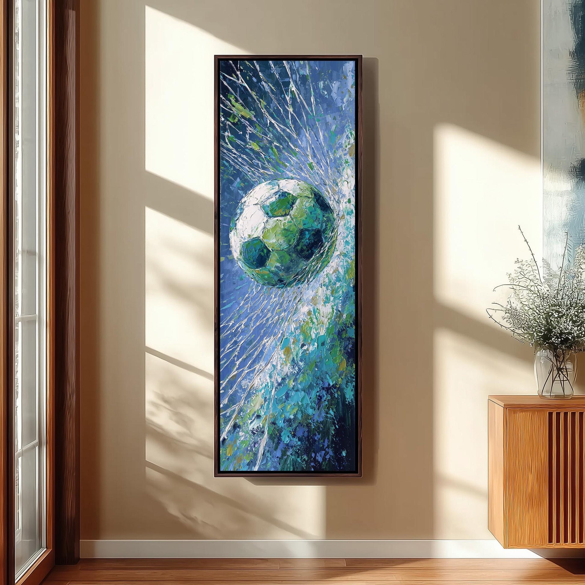 a large, colorful painting of a soccer ball suspended in mid-air, with a blue and green background and a white and green soccer ball. The painting is hanging on a wall in a room with a wooden cabinet and a vase of flowers.