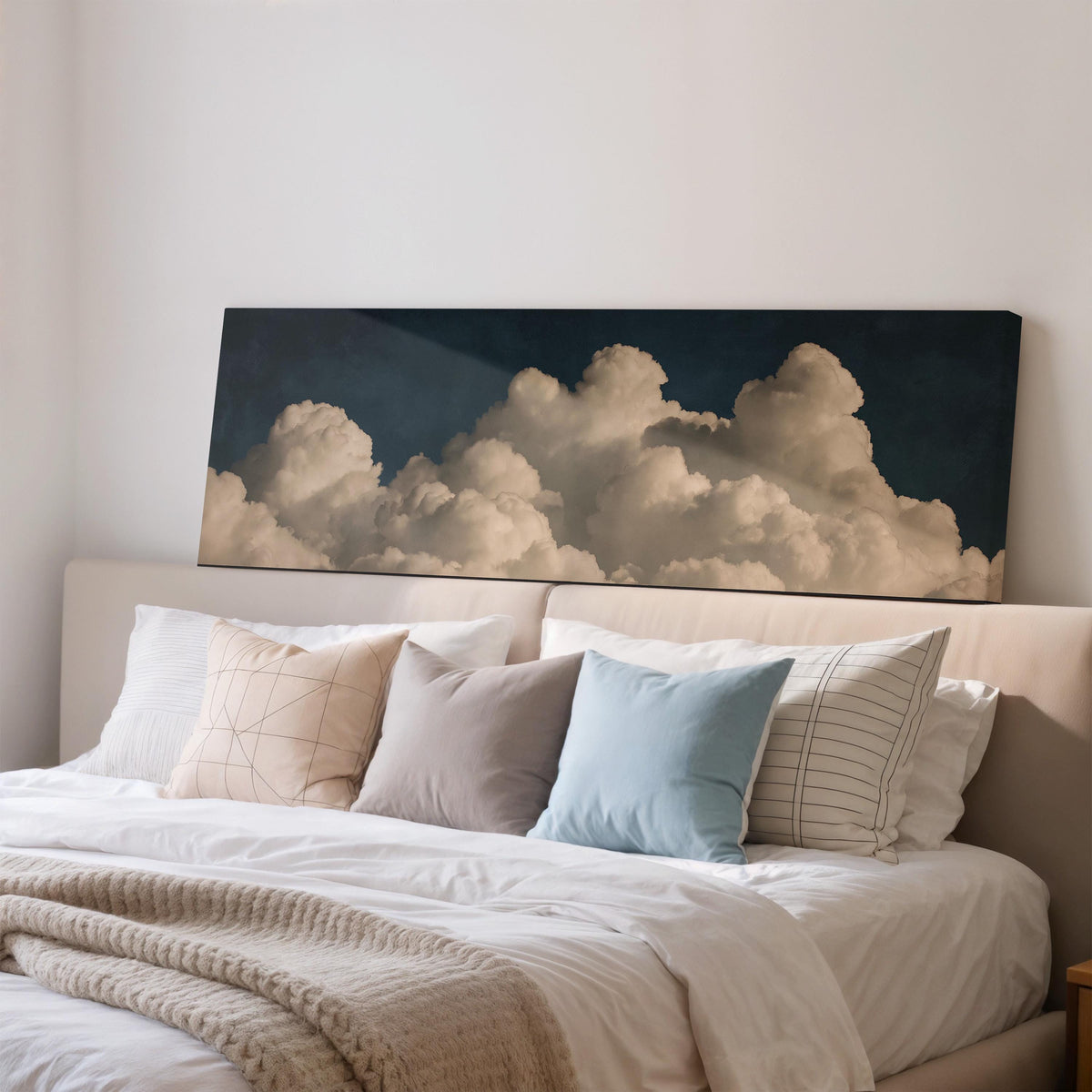 Cumulus clouds against a dark night sky wide panoramic canvas print above a bed in a bedroom