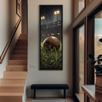 a soccer ball surrounded by grass, with a framed picture of a soccer stadium in the background.