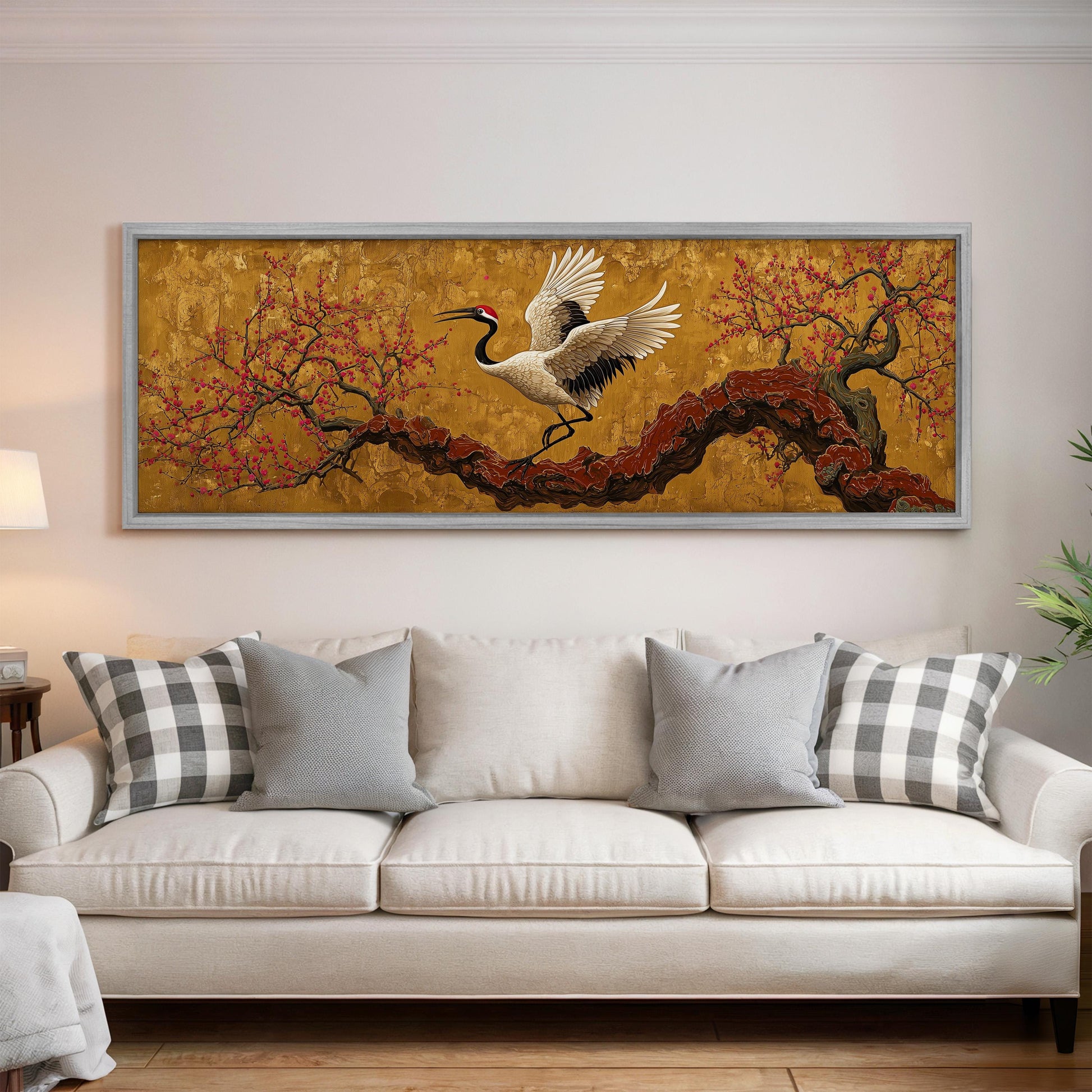 a large, framed painting of a crane in flight above a white couch in a living room setting.
