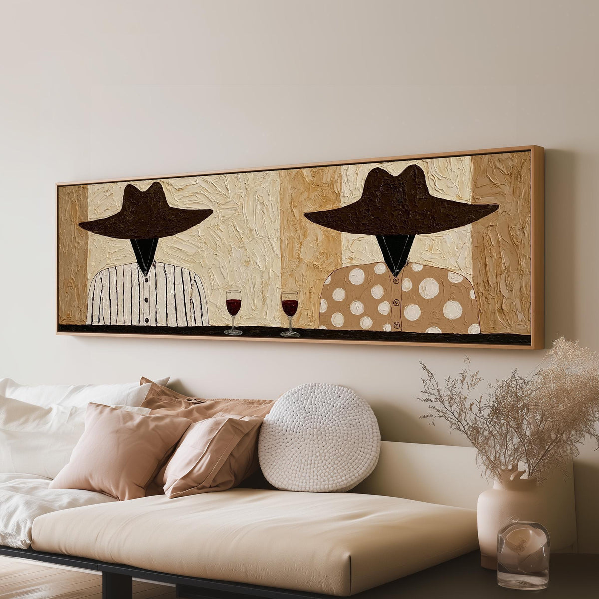 Two folk figures in hats toasting with red wine long horizontal canvas print above a sofa in a living room