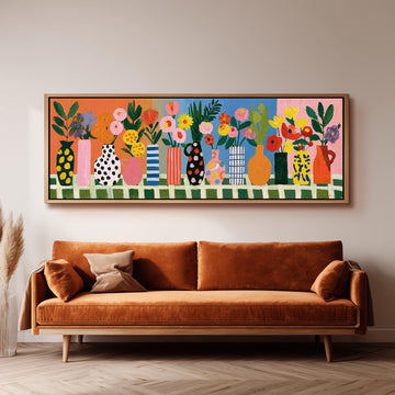Patterned vases with bright bouquets long horizontal canvas print above a sofa in a living room