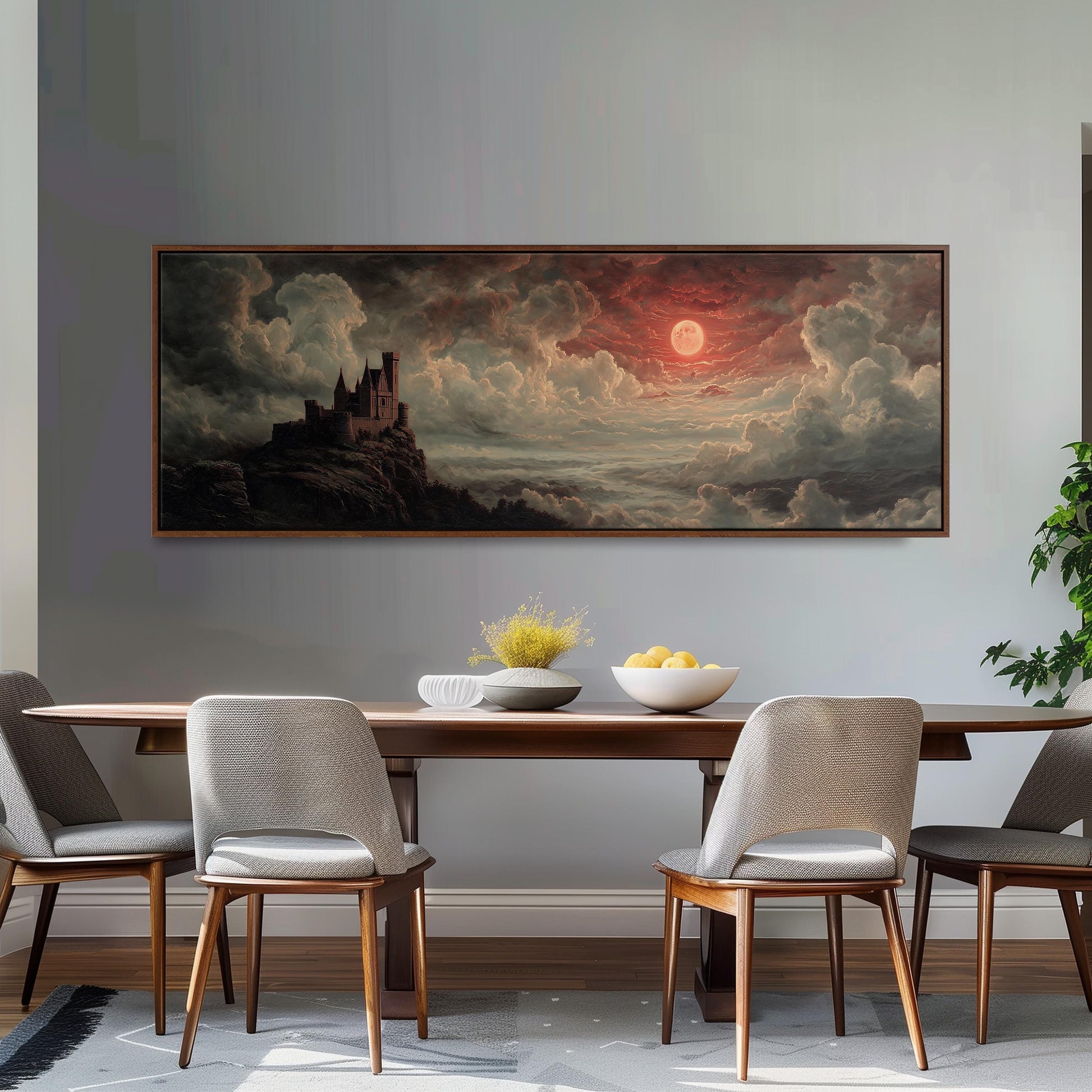 a large painting of a castle on a cliff, with a dramatic sky and clouds in the background, hanging on a wall above a wooden dining table with four chairs.