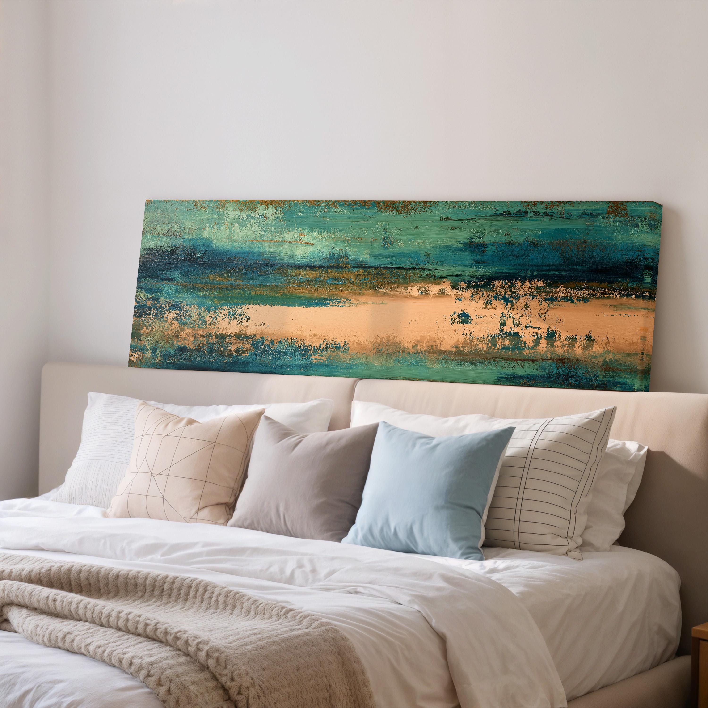 a bedroom with a large bed covered in white linens and a colorful abstract painting hanging above it.