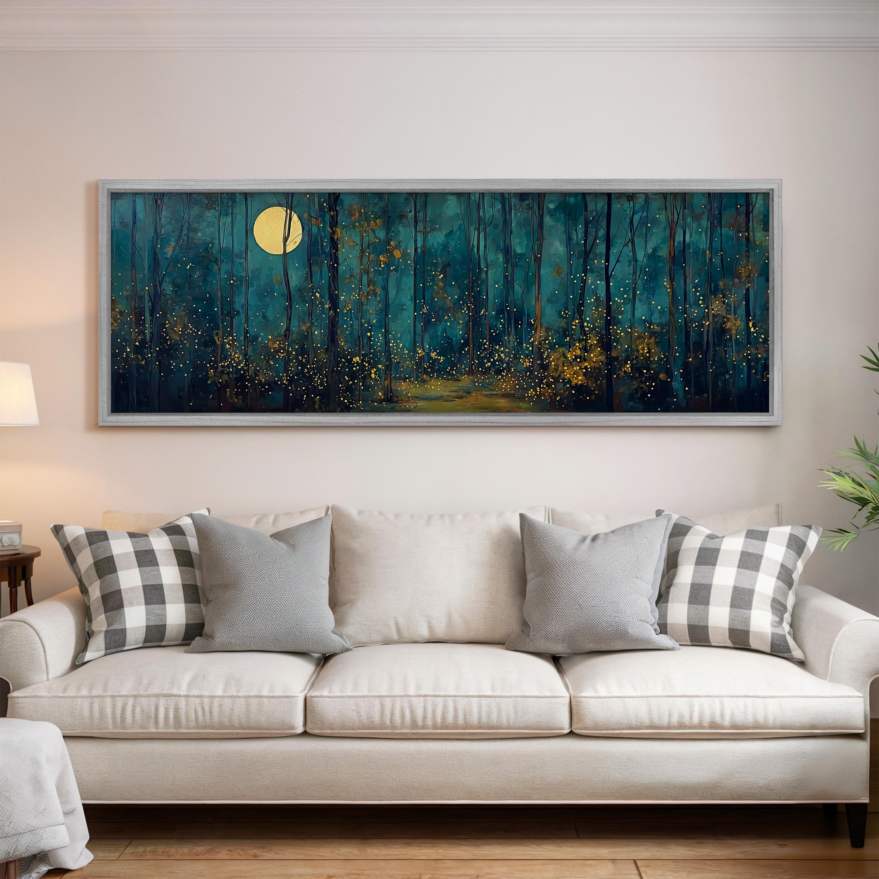a large, framed painting of a forest scene with a full moon in the background, hanging on a wall above a white sofa with patterned throw pillows.