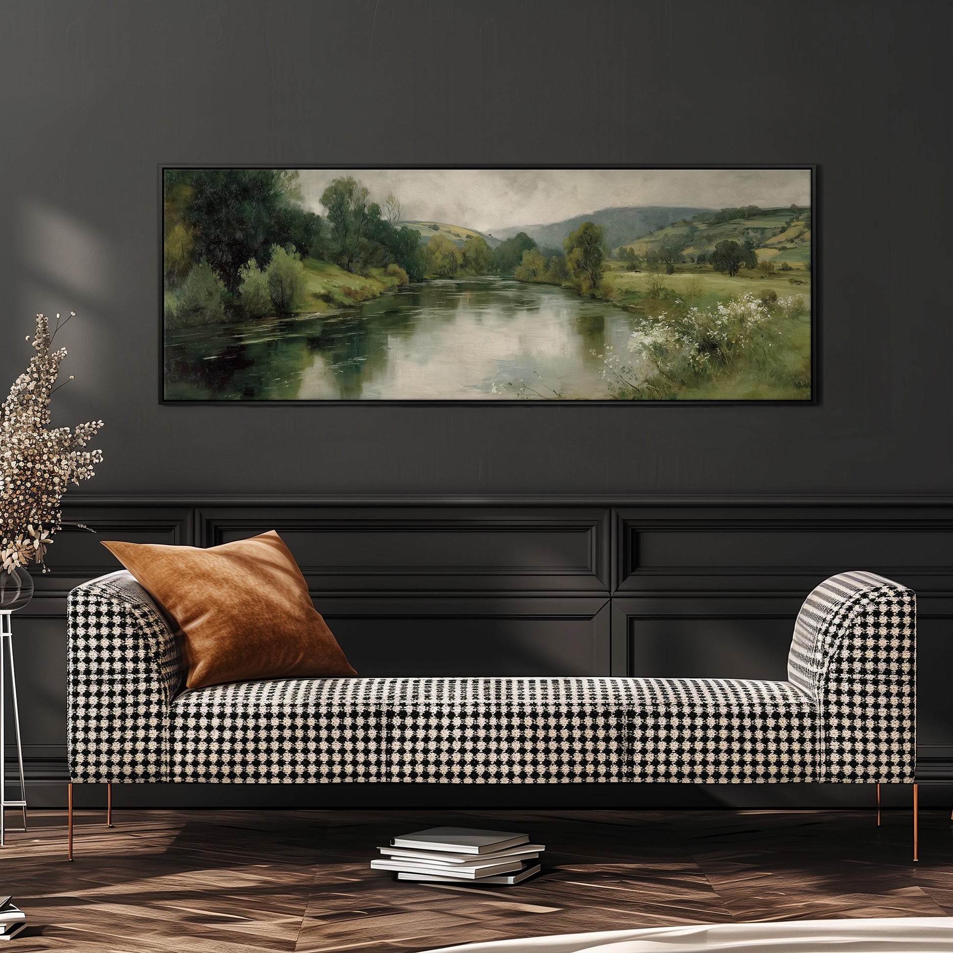 a large painting of a river and trees hanging on a wall above a black and white checkered sofa with a brown throw pillow.