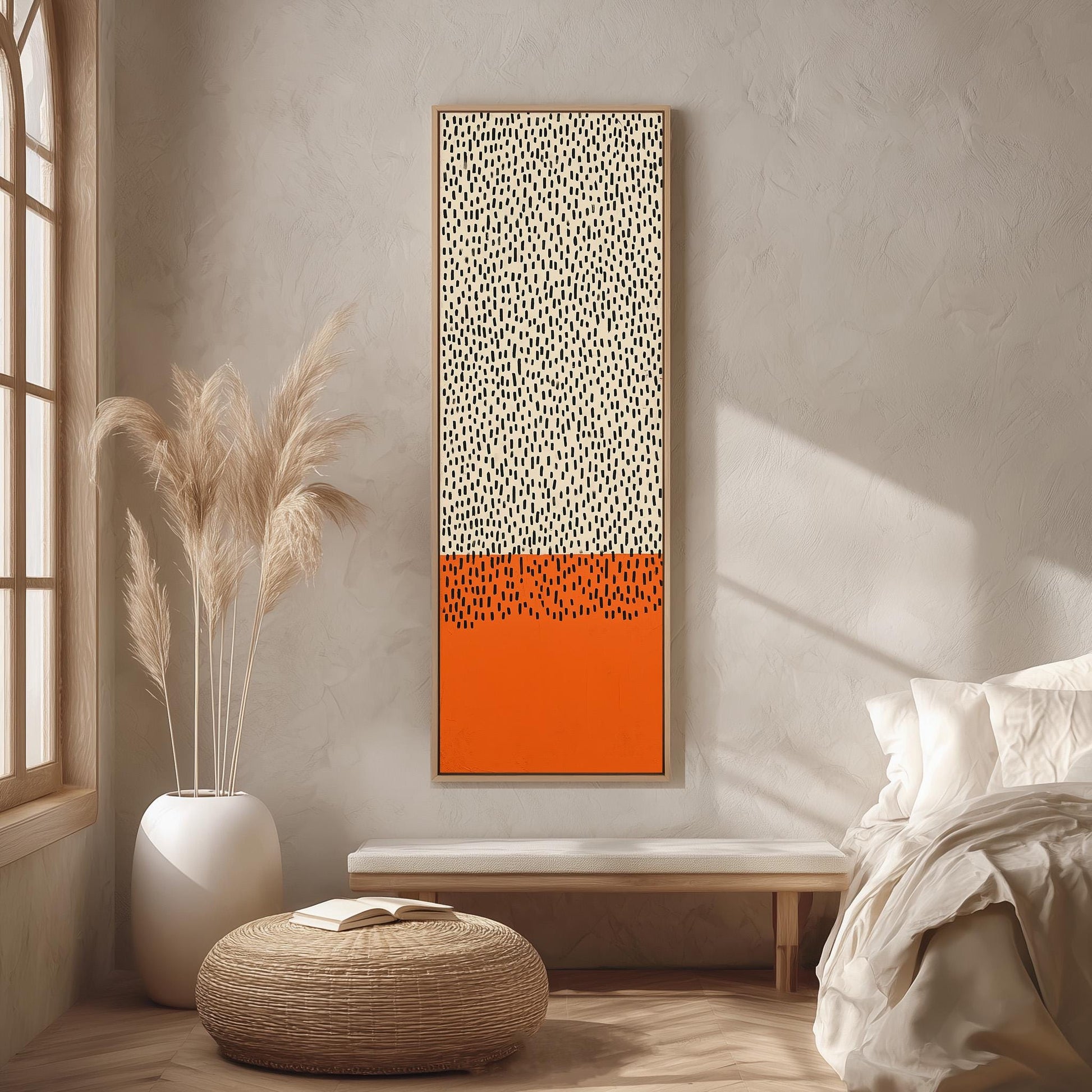 a minimalist bedroom interior with a large abstract painting featuring a bold orange and white color scheme hanging on the wall. The room is decorated with a white bed, a wicker ottoman, and a potted plant, creating a serene and modern atmosphere.