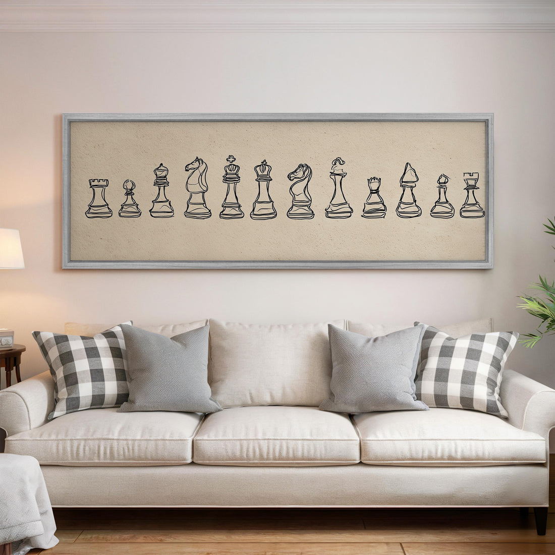 a large, framed artwork of chess pieces hanging on a wall above a brown sofa.