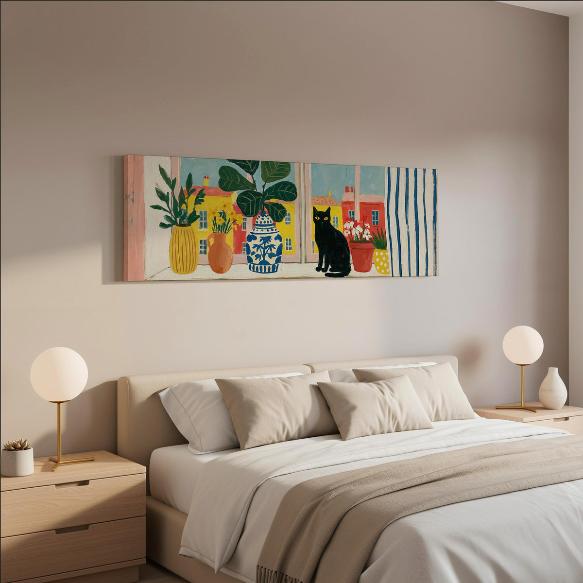 Black cat on a windowsill overlooking a colorful village wide panoramic canvas print above a bed in a neutral bedroom
