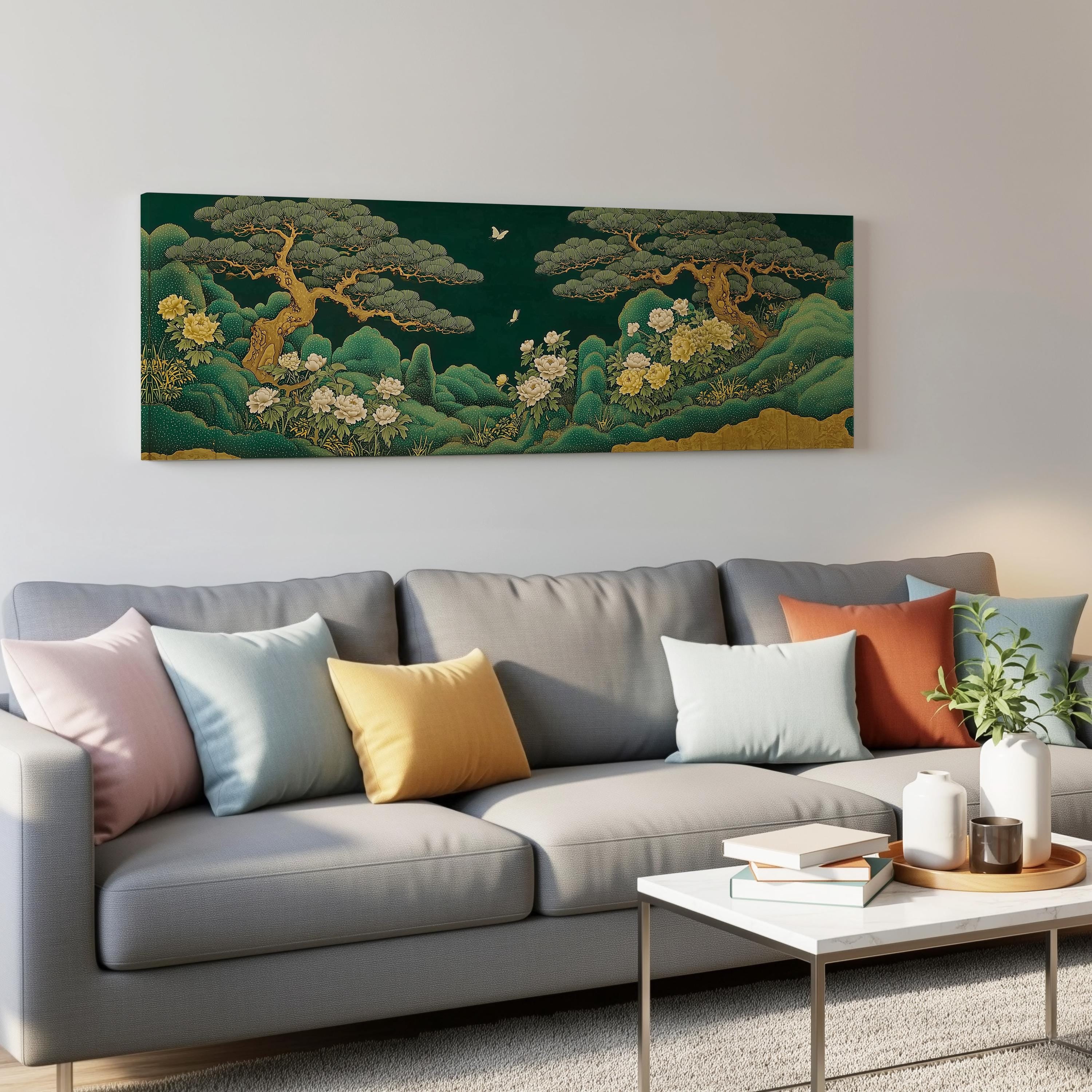 a large, colorful painting of a lush, verdant landscape hanging on a wall above a gray couch adorned with throw pillows. The couch is positioned in front of a coffee table, which holds a few books and a small plant. The overall scene creates a cozy and inviting atmosphere in the living room.