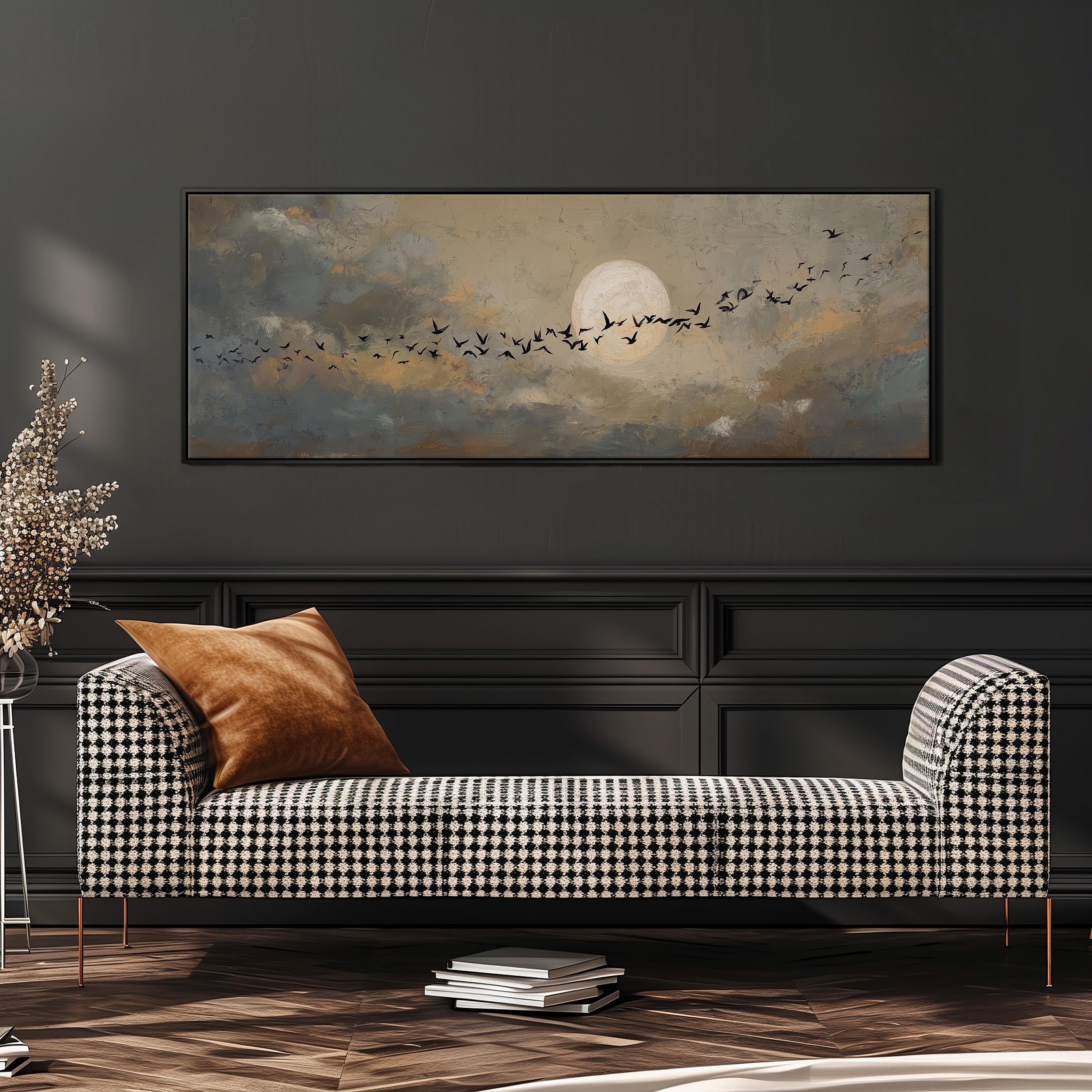a large painting of a flock of birds against a cloudy sky, hanging on a wall above a black and white checkered sofa.