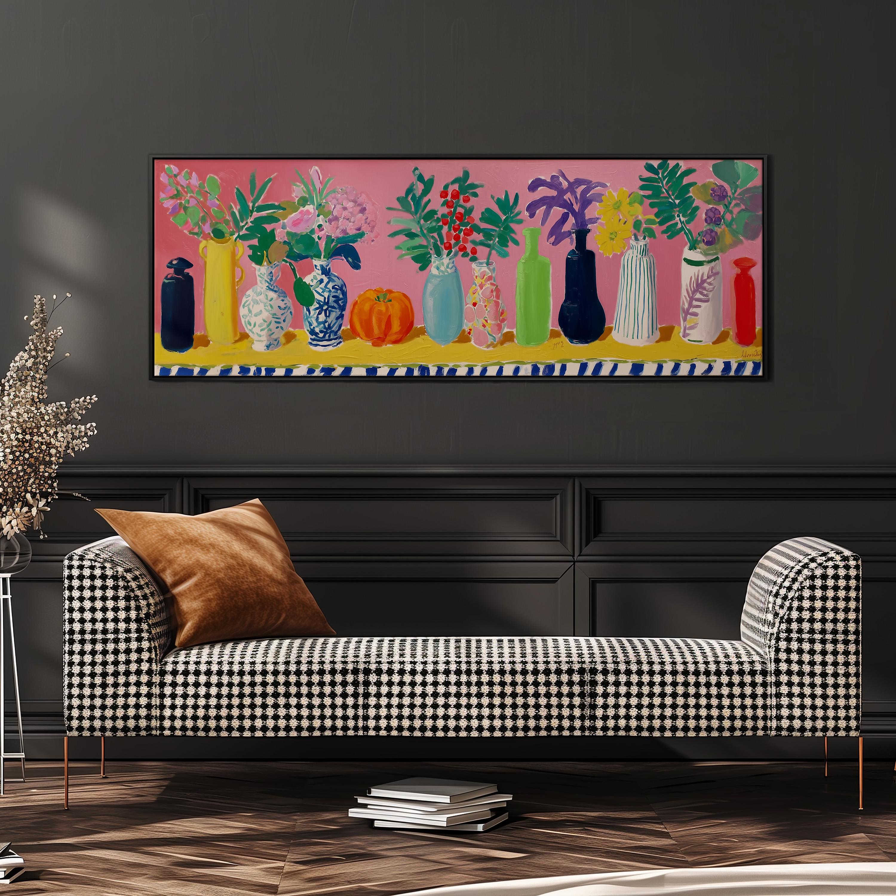 a checkered sofa with a stack of books on the floor in front of it, and a large painting of colorful vases hanging on the wall above.