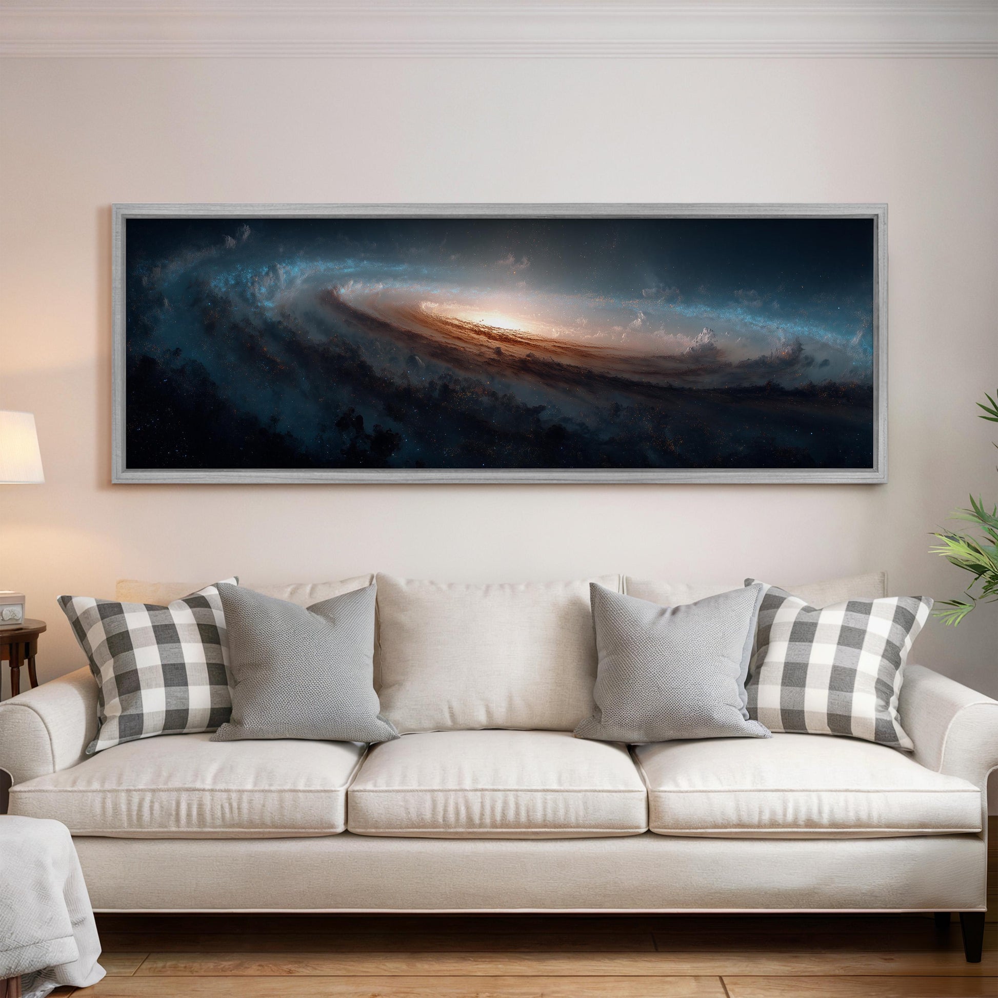 a large, framed painting of a spiral galaxy hanging on a wall above a white couch with gray and white plaid throw pillows.
