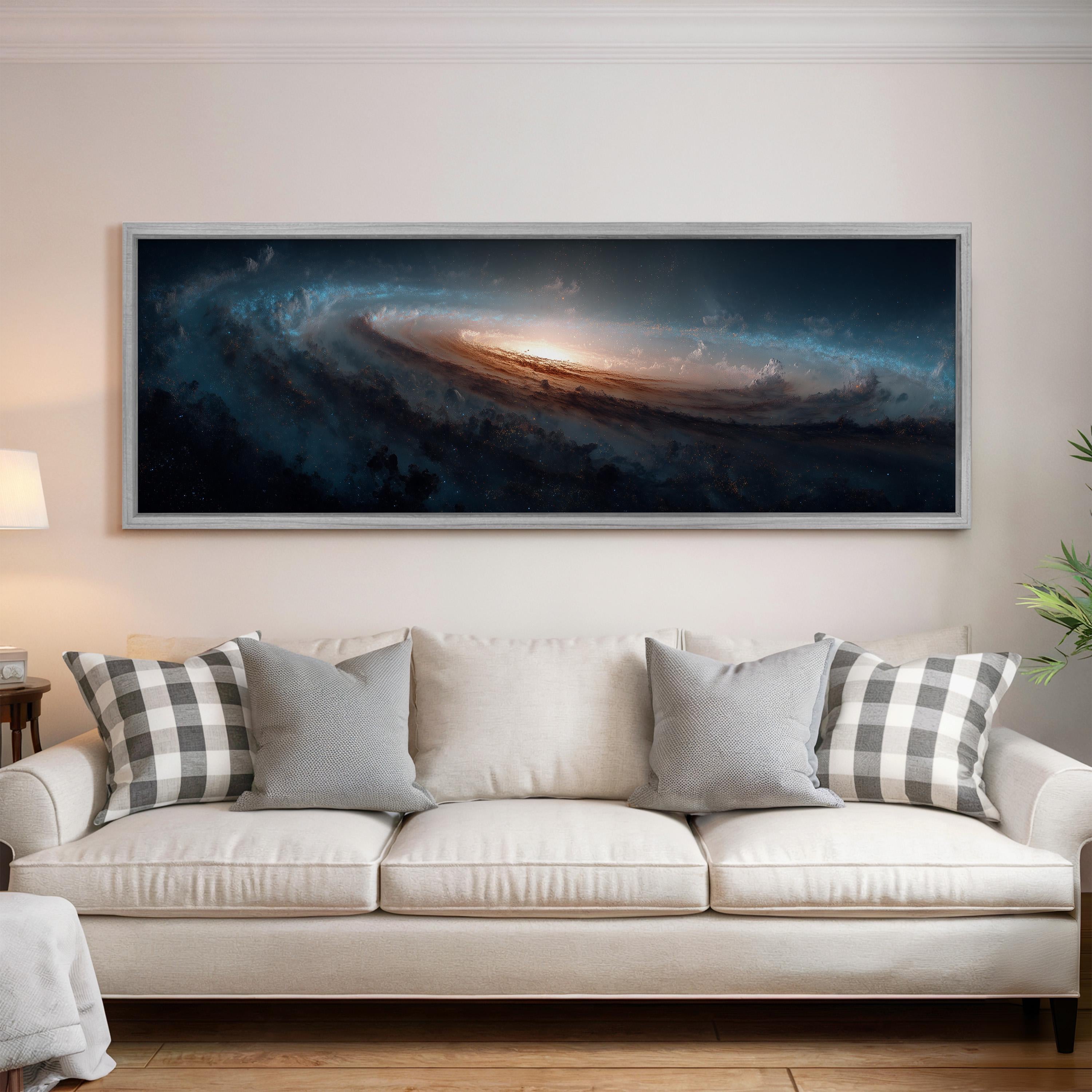 a large, framed painting of a spiral galaxy hanging on a wall above a white couch with gray and white plaid throw pillows.