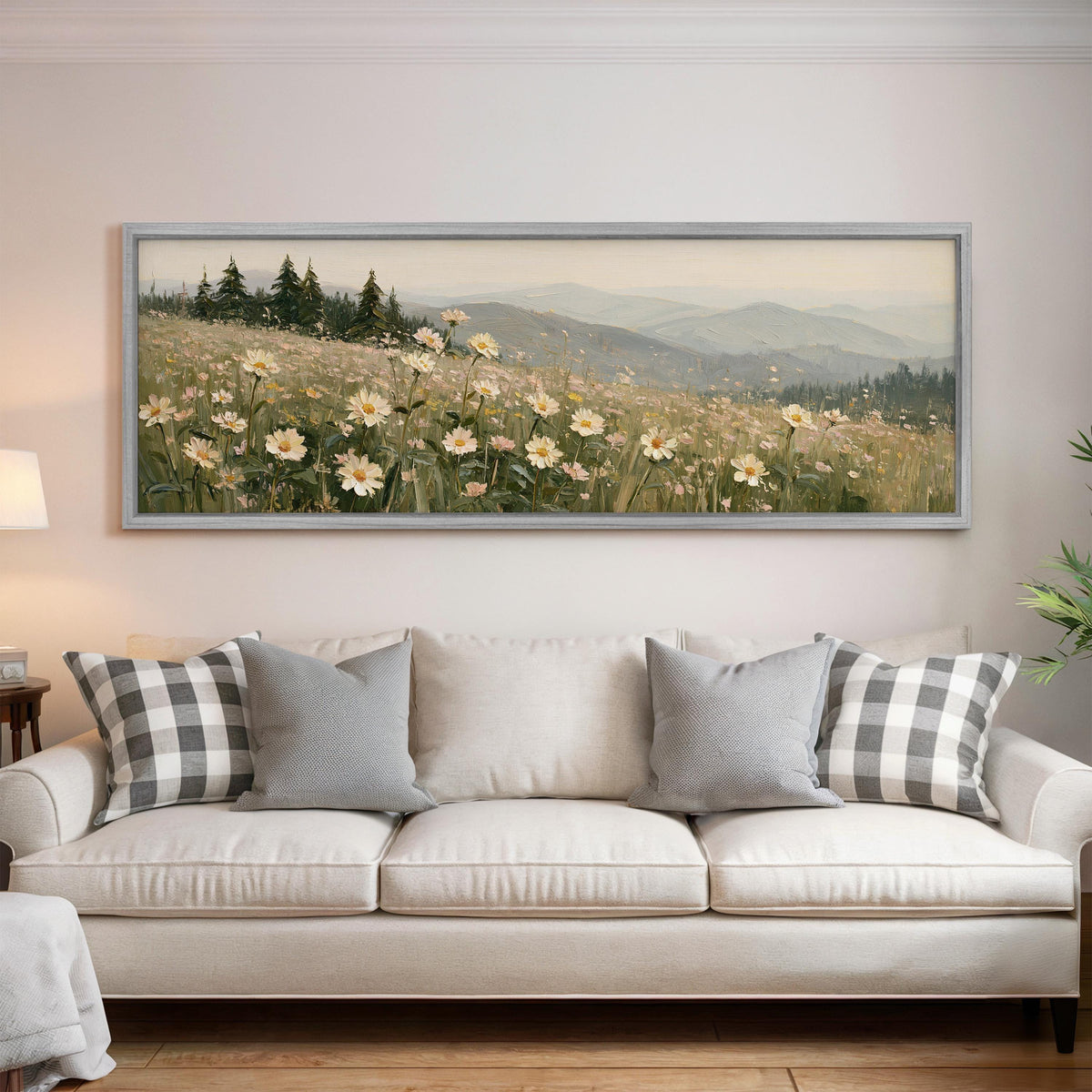 Daisy hillside below blue mountains panoramic canvas print above a white sofa in a bright living room