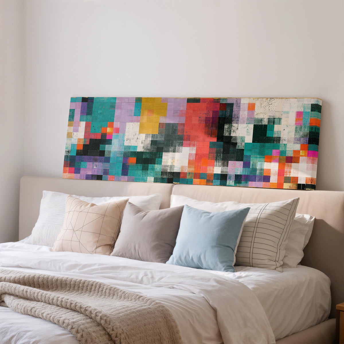 Teal and coral patchwork color blocks wide panoramic canvas print above a bed in a bedroom