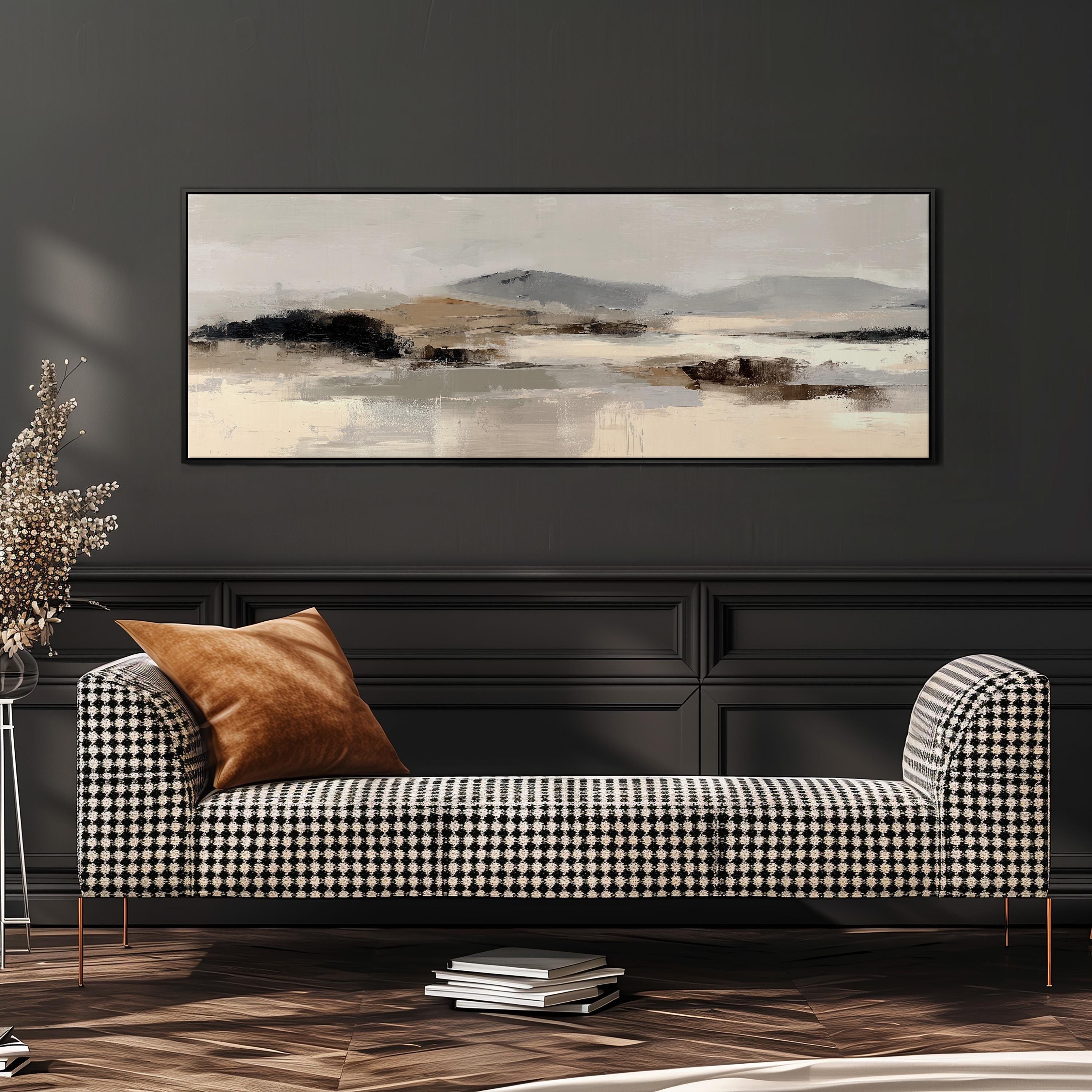 a modern living room with a black and white checkered sofa, a large abstract painting on the wall, and a stack of books on the floor.