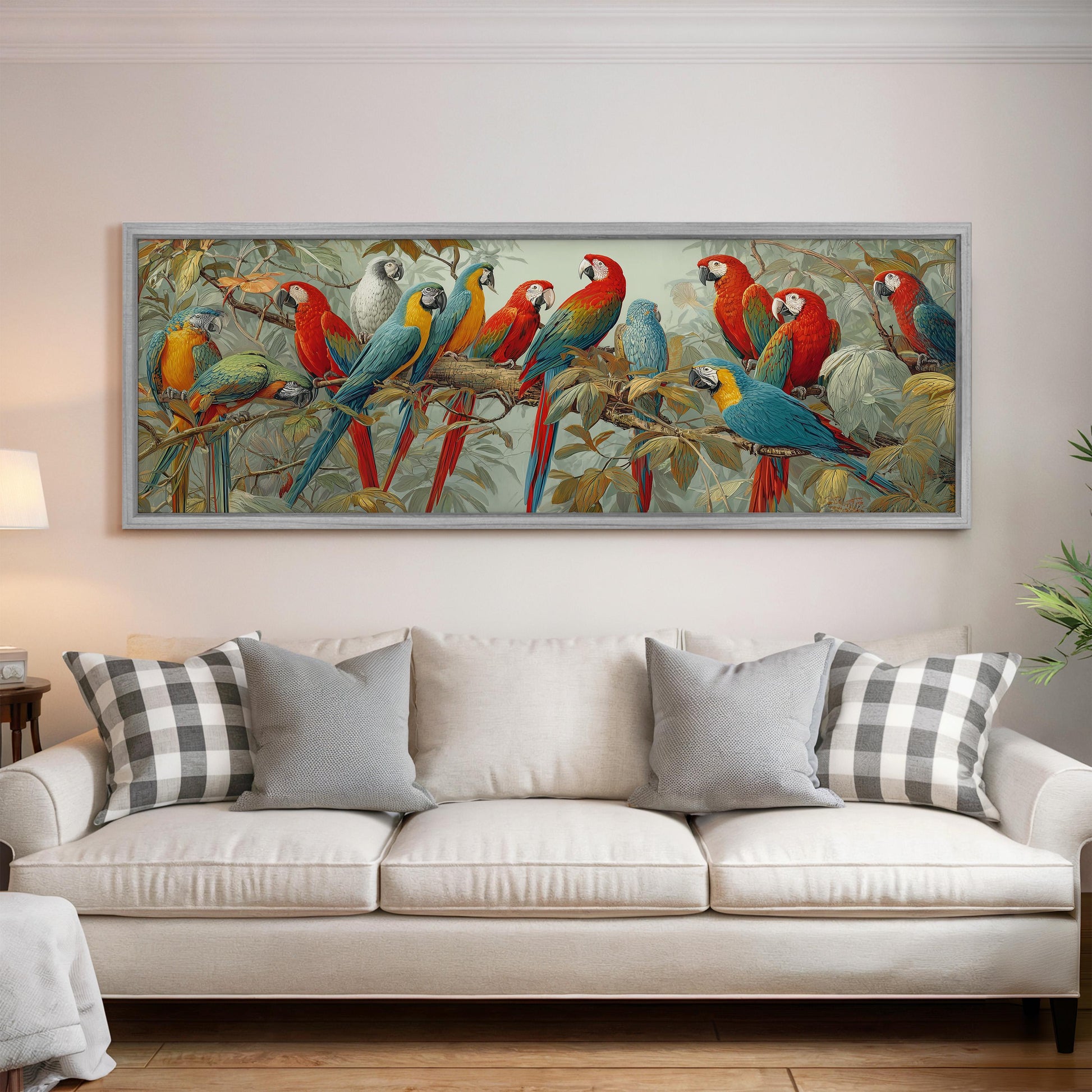 a large painting of colorful parrots perched on branches, hanging on a wall above a white couch with gray and white plaid throw pillows.