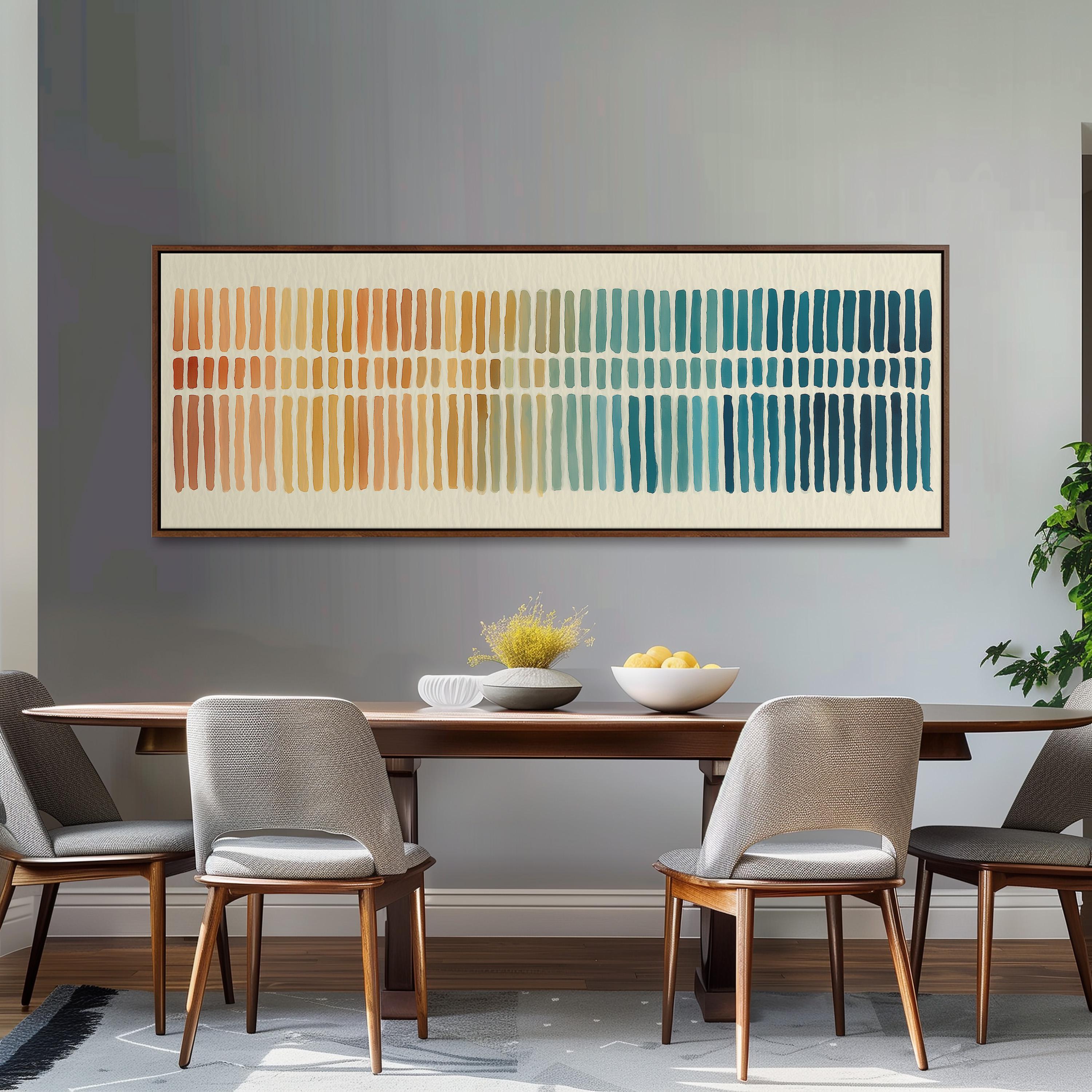 a dining room with a wooden table and four gray chairs. Above the table, there is a large abstract painting with horizontal stripes in various colors, including orange, yellow, green, blue, and white. The painting is framed and hangs on the wall above the table.
