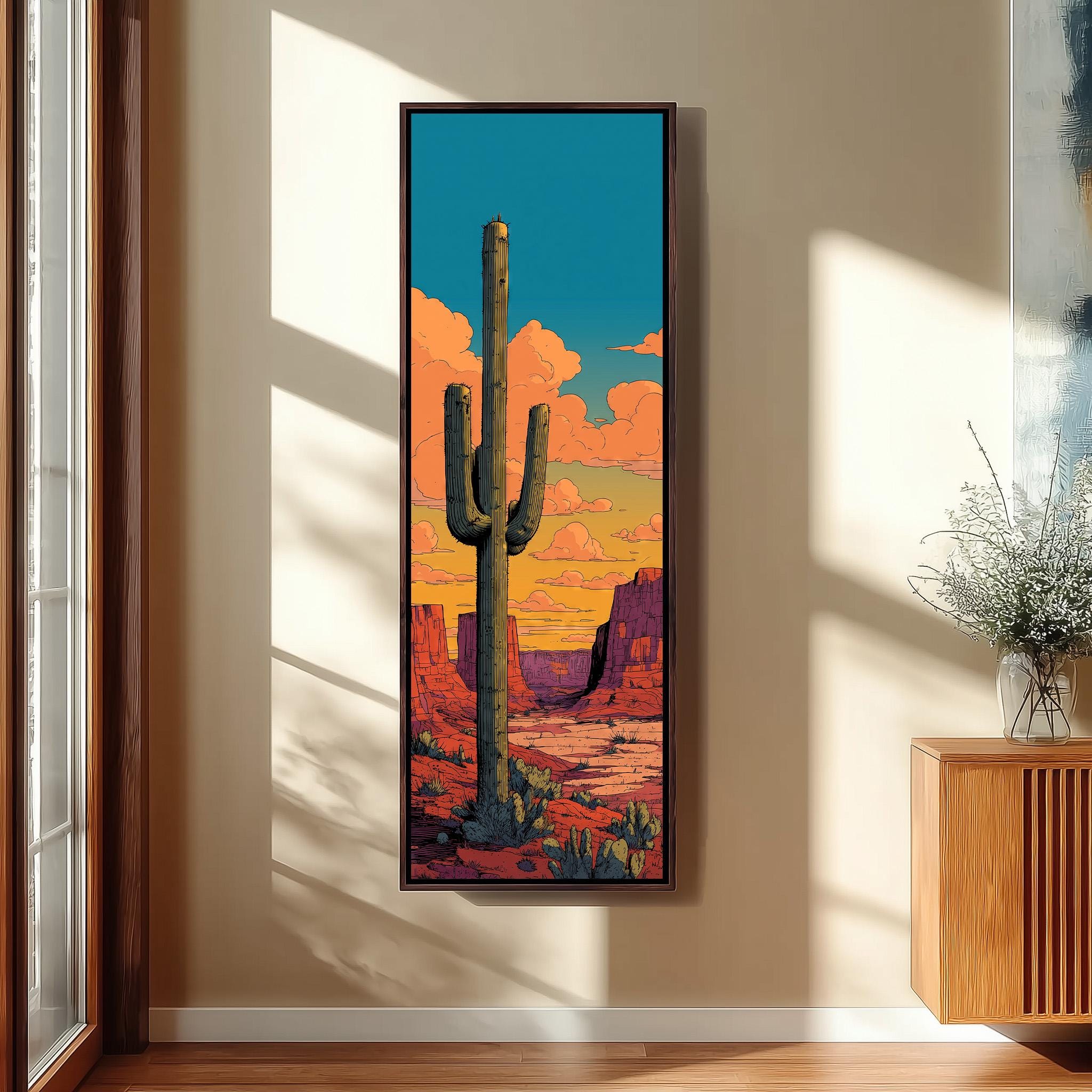 a large framed painting of a cactus in a desert landscape, with a colorful sky in the background.