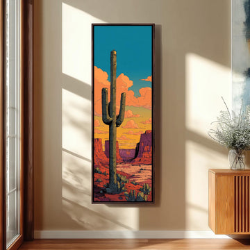 a large framed painting of a cactus in a desert landscape, with a colorful sky in the background.