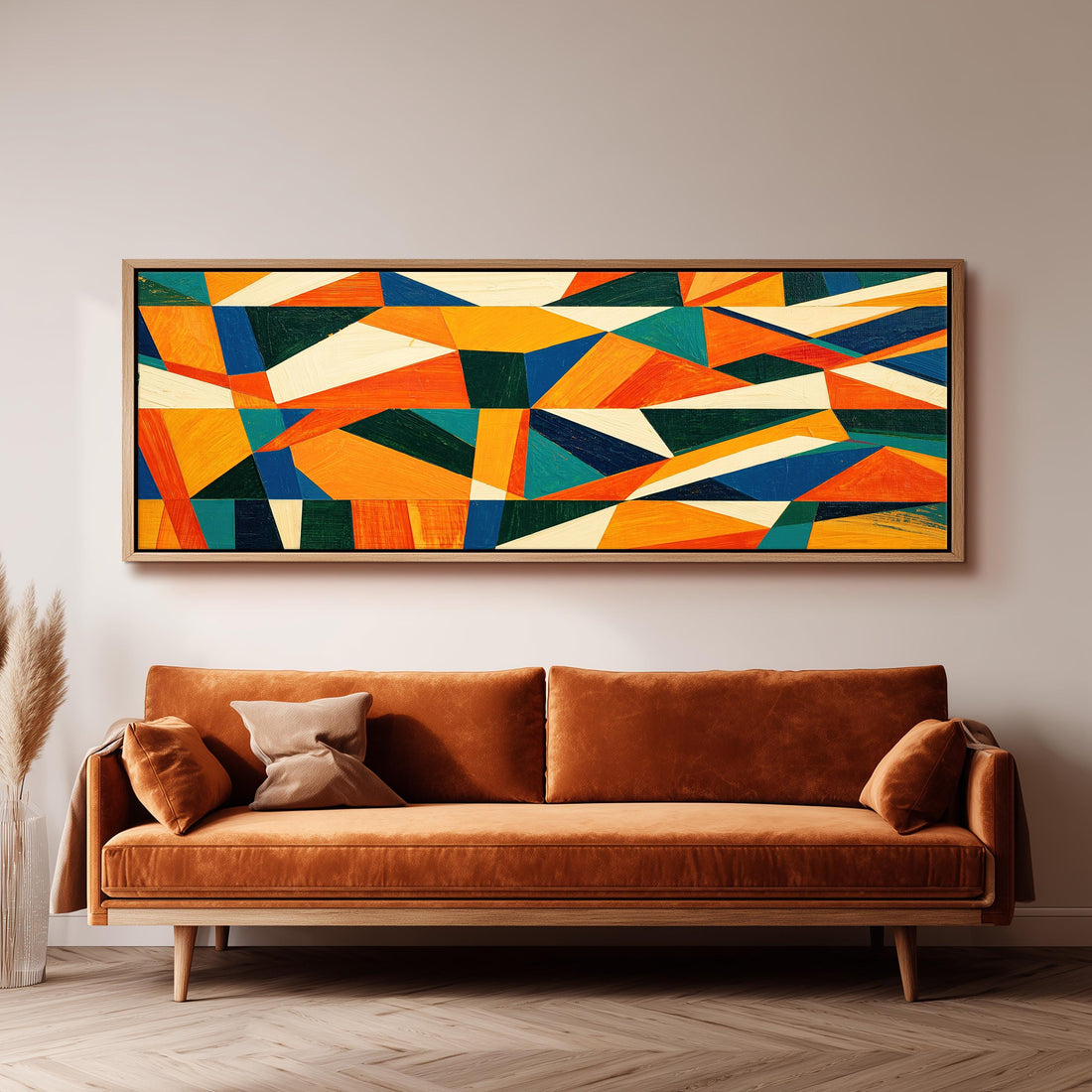 Orange and teal triangle mosaic long horizontal canvas print above a sofa in a living room