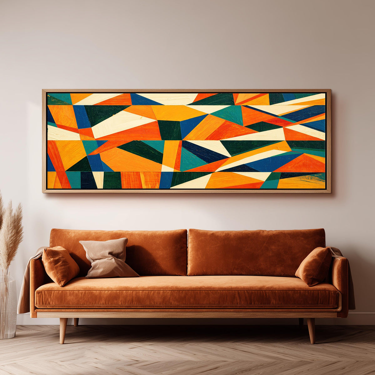 Orange and teal triangle mosaic long horizontal canvas print above a sofa in a living room