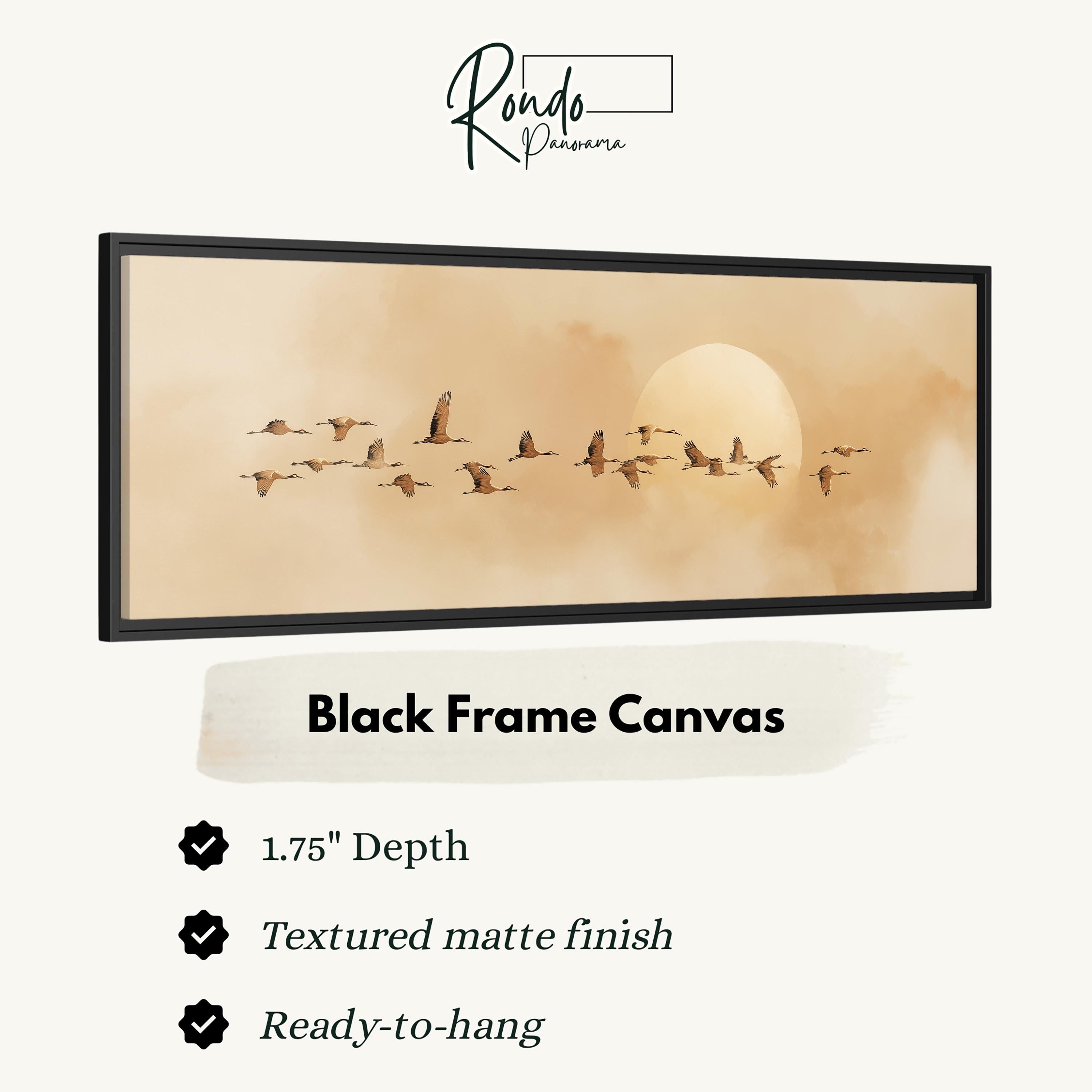 A black frame canvas depicting a flock of birds flying in the sky.