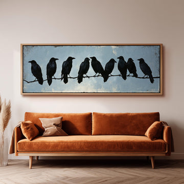 Crows gathered on a branch long horizontal canvas print above a sofa in a living room