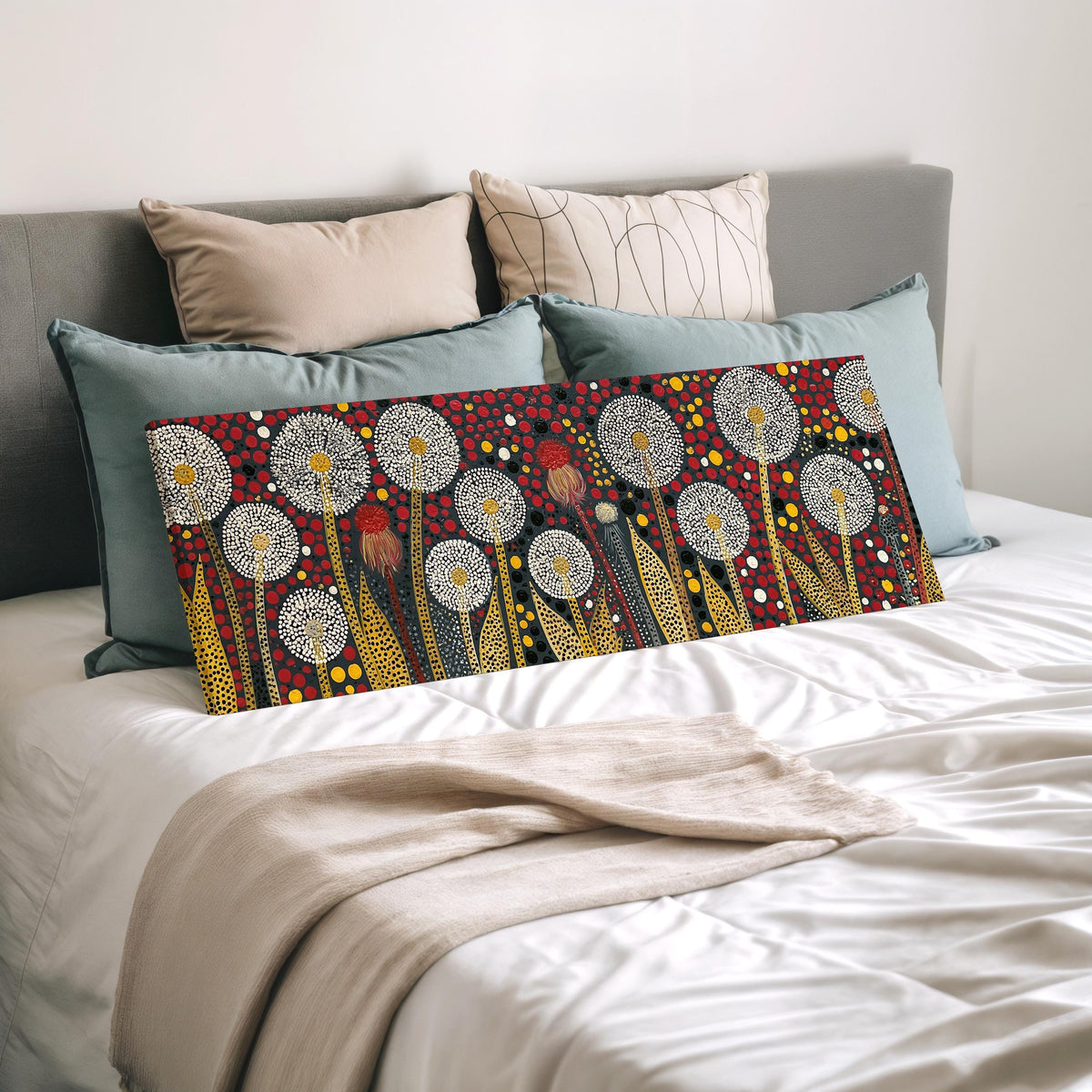 Dotted dandelions on deep red wide panoramic canvas print laid on a bed to show its size