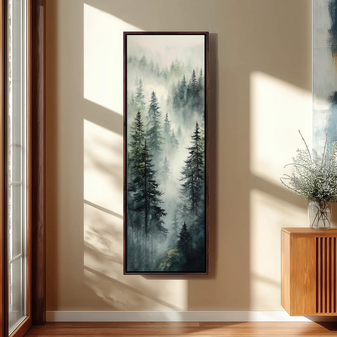 a large painting of a forest scene hanging on a wall, with sunlight streaming in through a window and casting shadows on the wall.