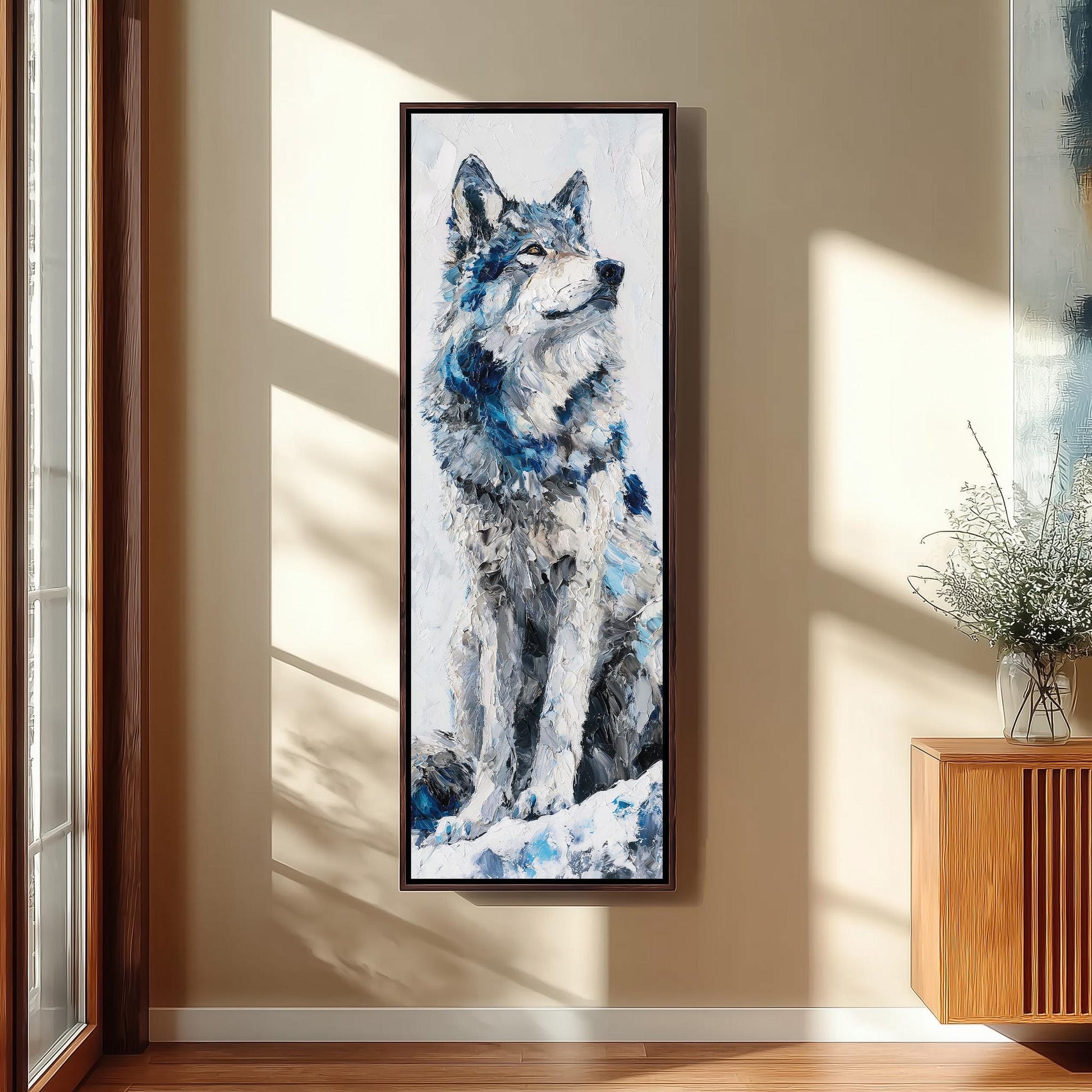 a large painting of a wolf sitting on a snowy surface, hanging on a wall in a room with a wooden floor.