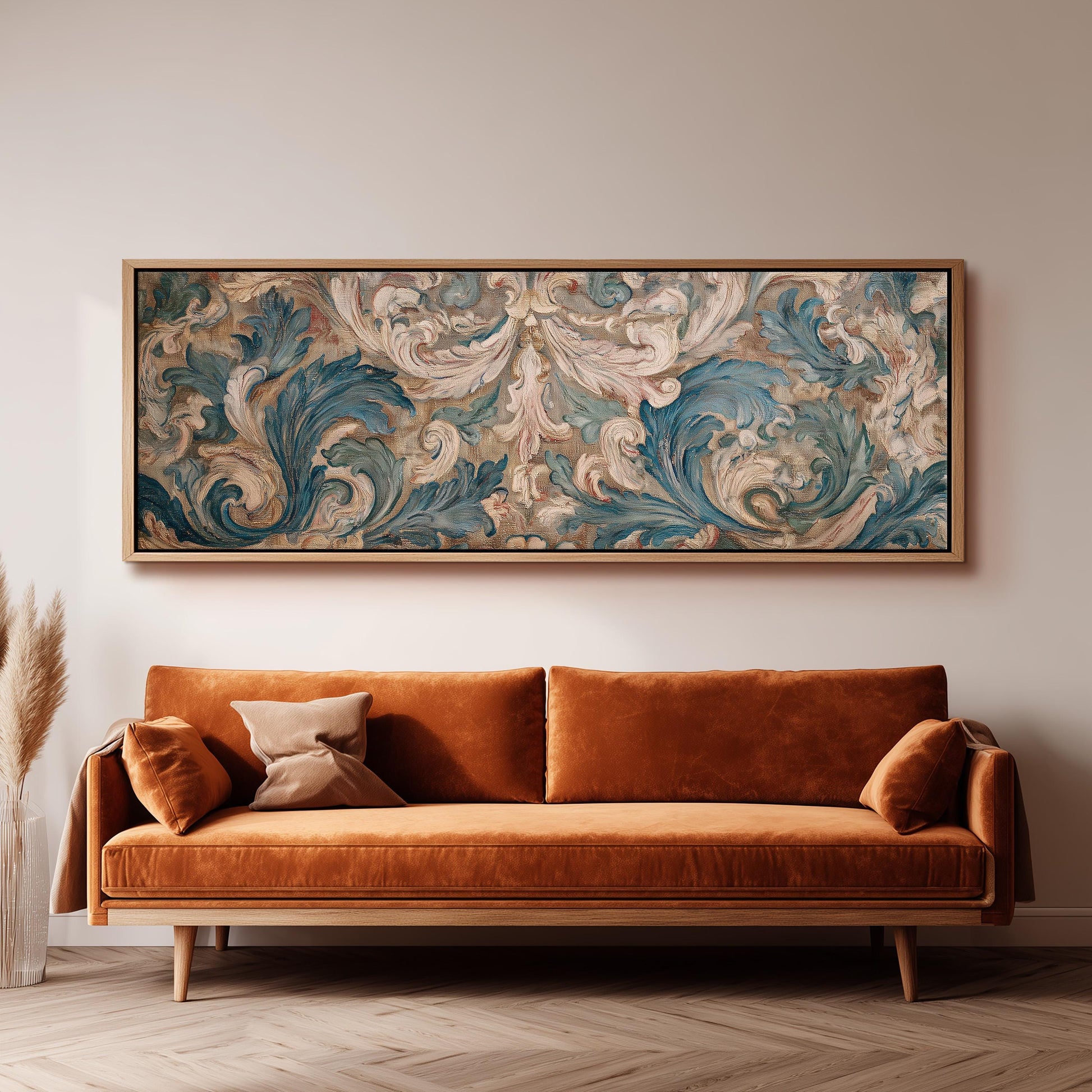 a large, ornate painting hanging on a wall above a brown sofa with orange cushions.