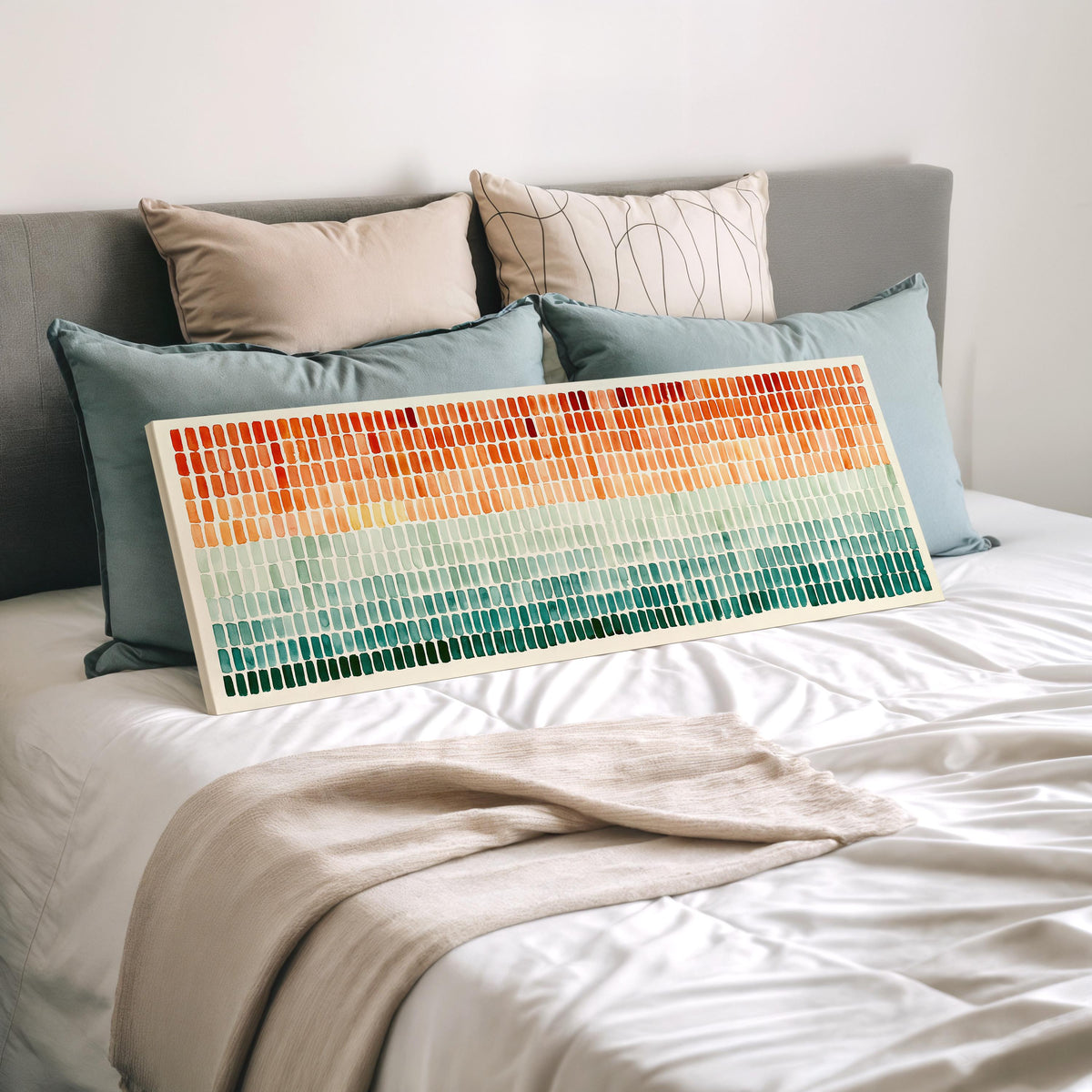 Brushmarks fading from orange to teal wide panoramic canvas print laid on a bed to show its size
