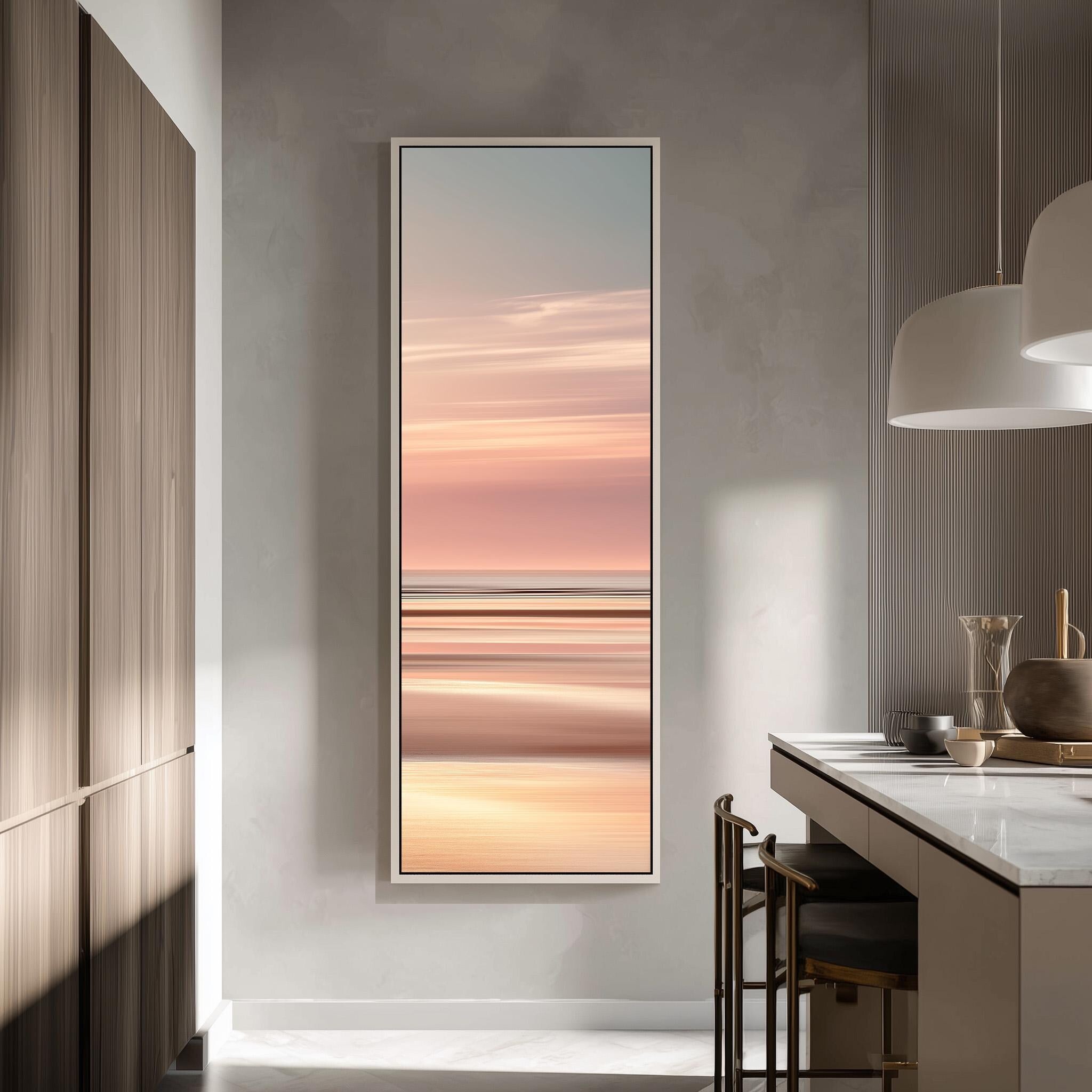 a modern kitchen with a large window that offers a view of a sunset. The kitchen has a minimalist design with a white countertop and a wooden cabinet. There is a dining table with chairs, and a pendant light hanging above it. The overall atmosphere of the image is calm and serene, with the warm colors of the sunset creating a peaceful ambiance.