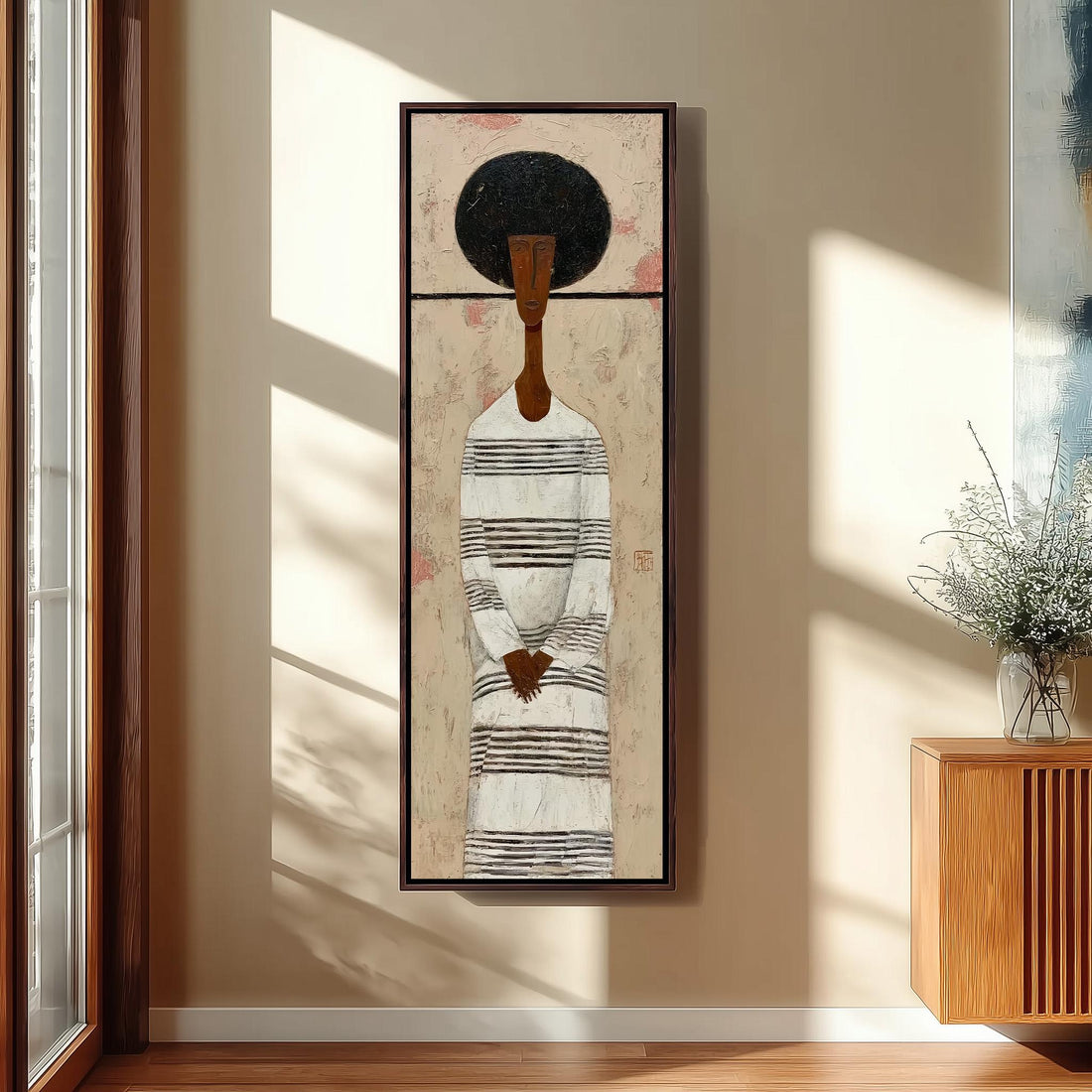 a large painting of a woman with a black afro hairstyle, wearing a striped dress, hanging on a white wall in a room with a wooden chair and a small table.