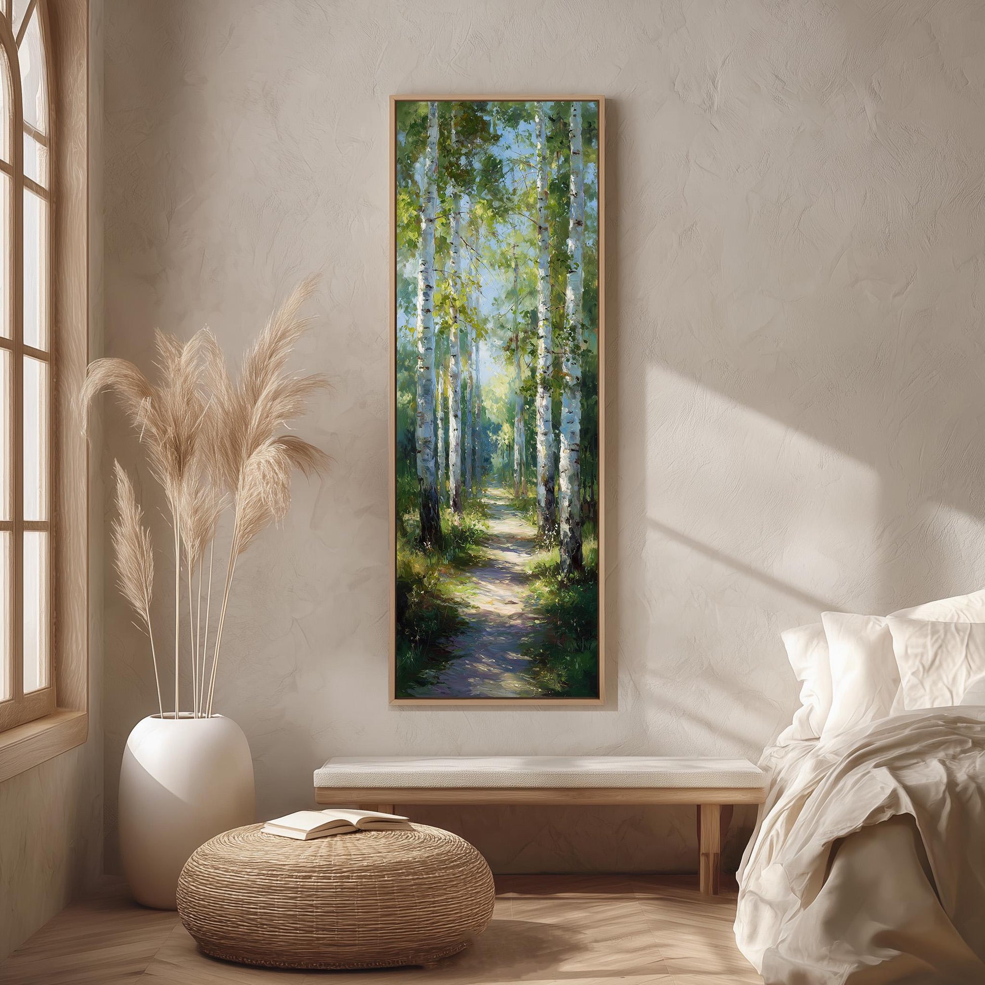 a serene indoor setting with a large painting of a forest path hanging on the wall. The painting features tall trees with green foliage and a winding path, creating a sense of tranquility and connection to nature. The room is decorated with a white sofa, a wicker ottoman, and a potted plant, contributing to a cozy and inviting atmosphere.
