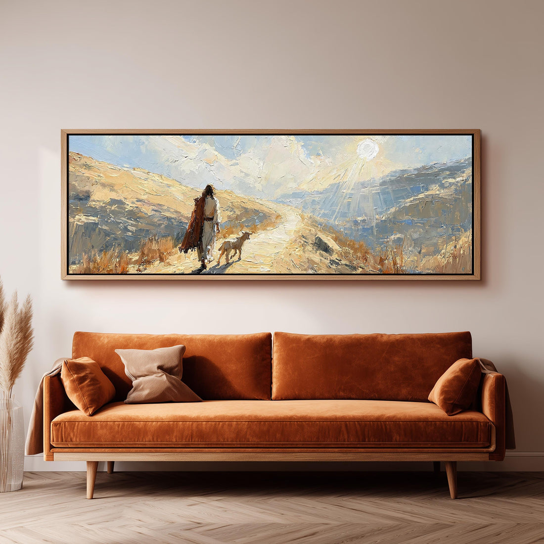 Jesus walking a sunlit hillside path with a sheep long horizontal canvas print above a sofa in a living room