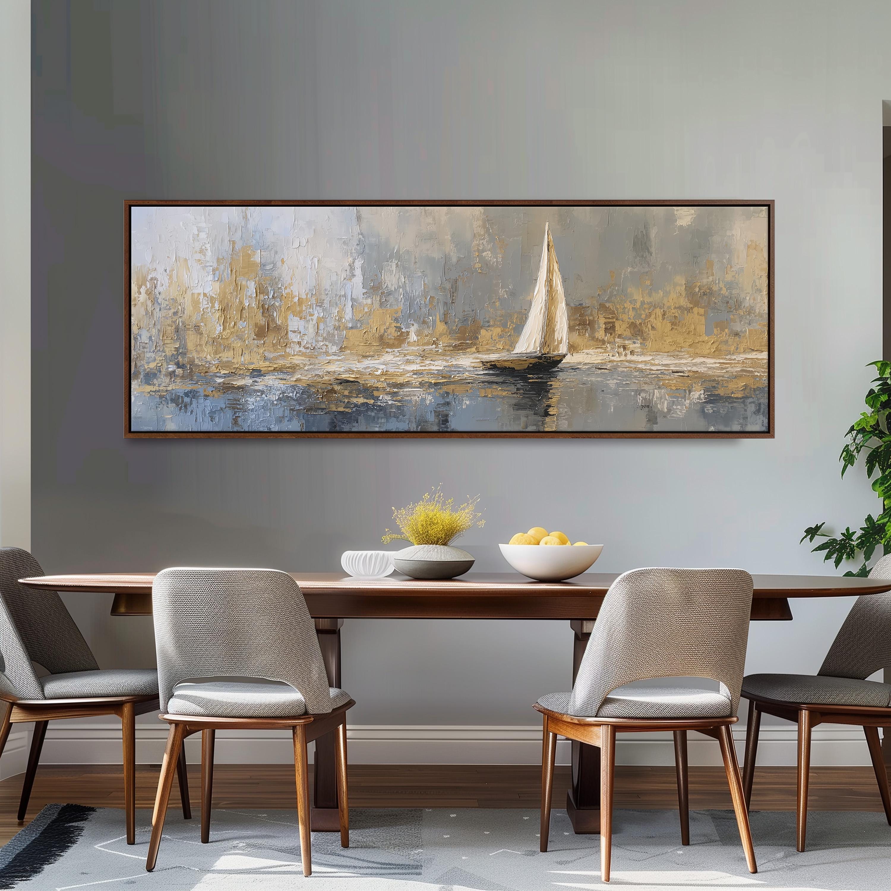 a large painting of a sailboat on a body of water, hanging on a wall above a wooden dining table with four chairs.