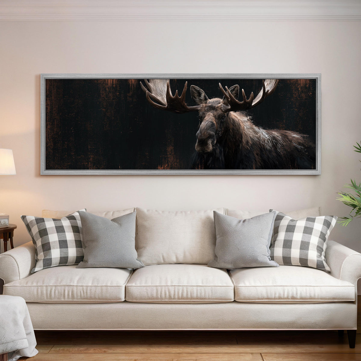 Dark moose portrait panoramic canvas print above a white sofa in a bright living room