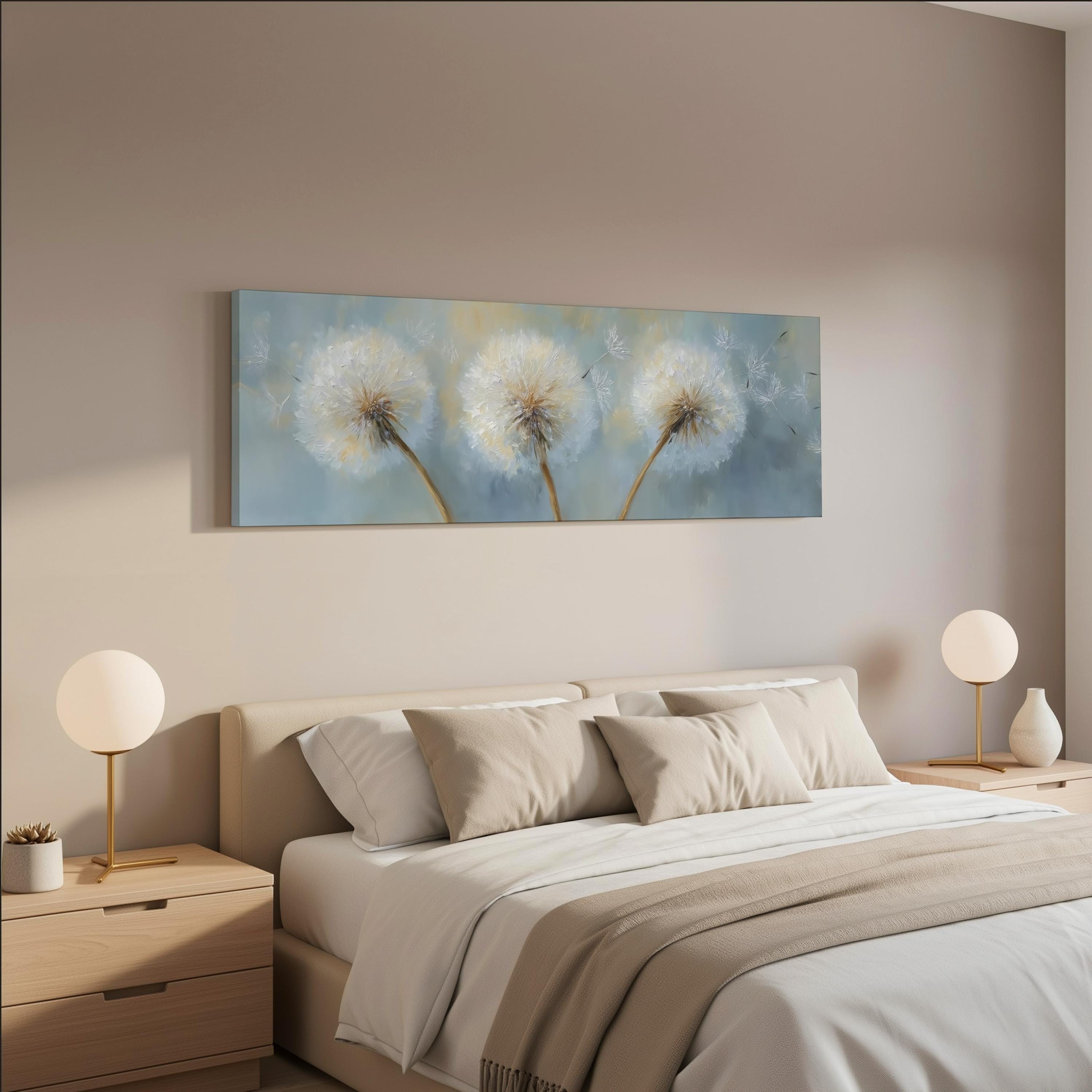 a serene bedroom scene with a large bed adorned with white pillows and a beige blanket. Above the bed, there is a painting of three dandelions in a blue and white color scheme. The room is decorated with two white lamps on nightstands, and the overall color scheme is predominantly neutral, creating a calm and peaceful atmosphere.