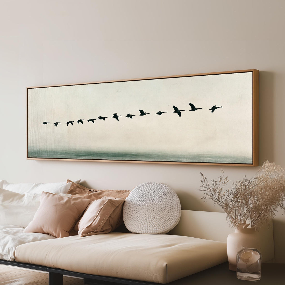 Geese flying over still water long horizontal canvas print above a sofa in a living room