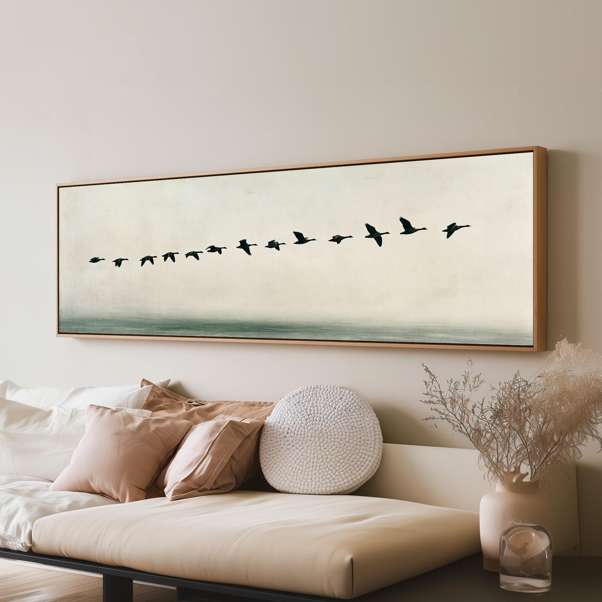 Geese flying over still water long horizontal canvas print above a sofa in a living room