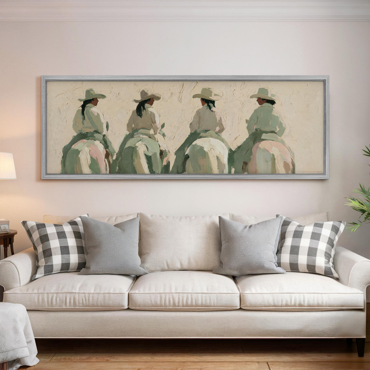 Cowgirl trail riders panoramic canvas print above a white sofa in a bright living room