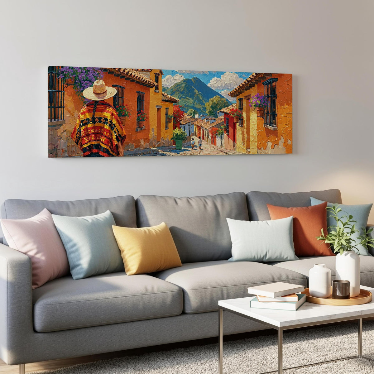Colorful Guatemalan street with volcano view panoramic canvas print above a grey sofa in a living room