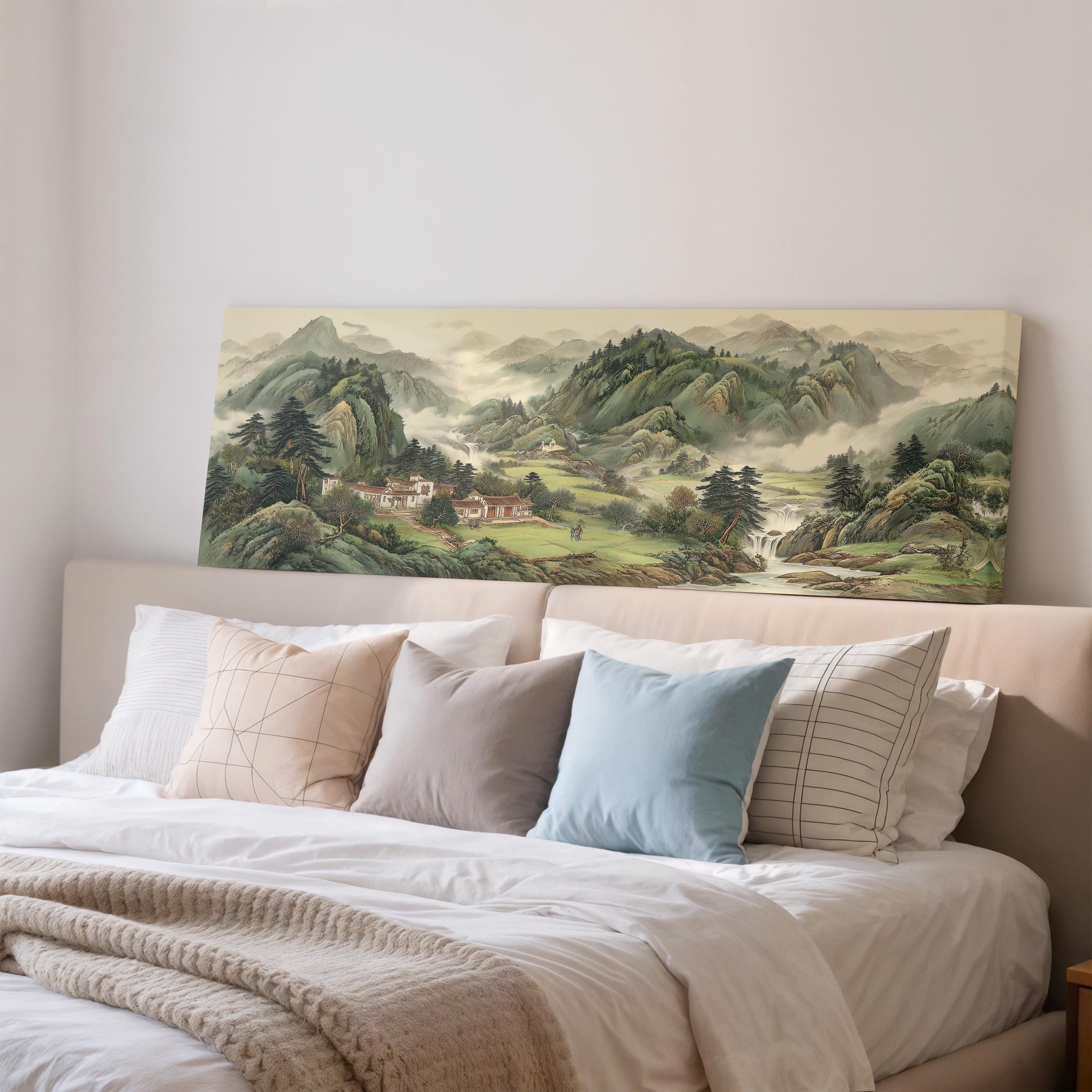 a large landscape painting hanging on a wall above a bed with white bedding and pillows.