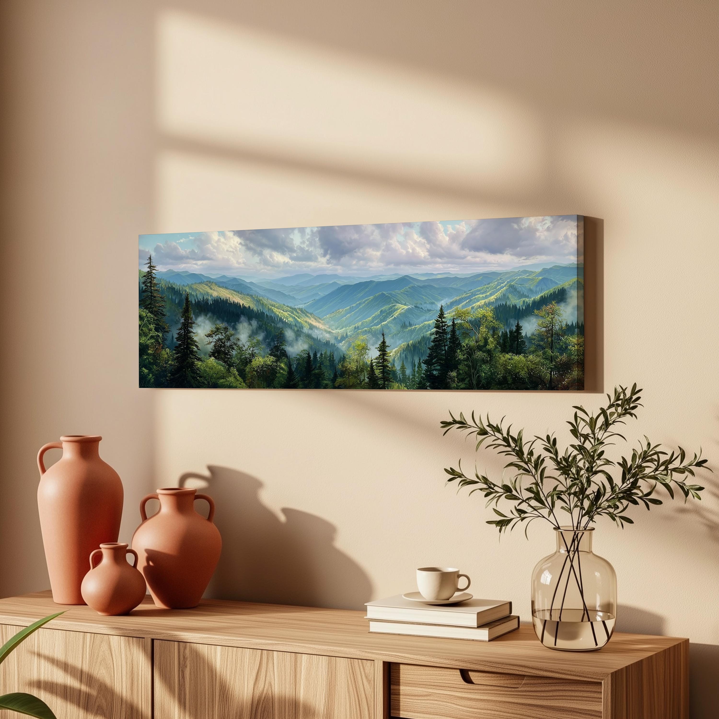a serene mountain landscape with a vase of greenery, a stack of books, and a wooden cabinet with a coffee cup on top.