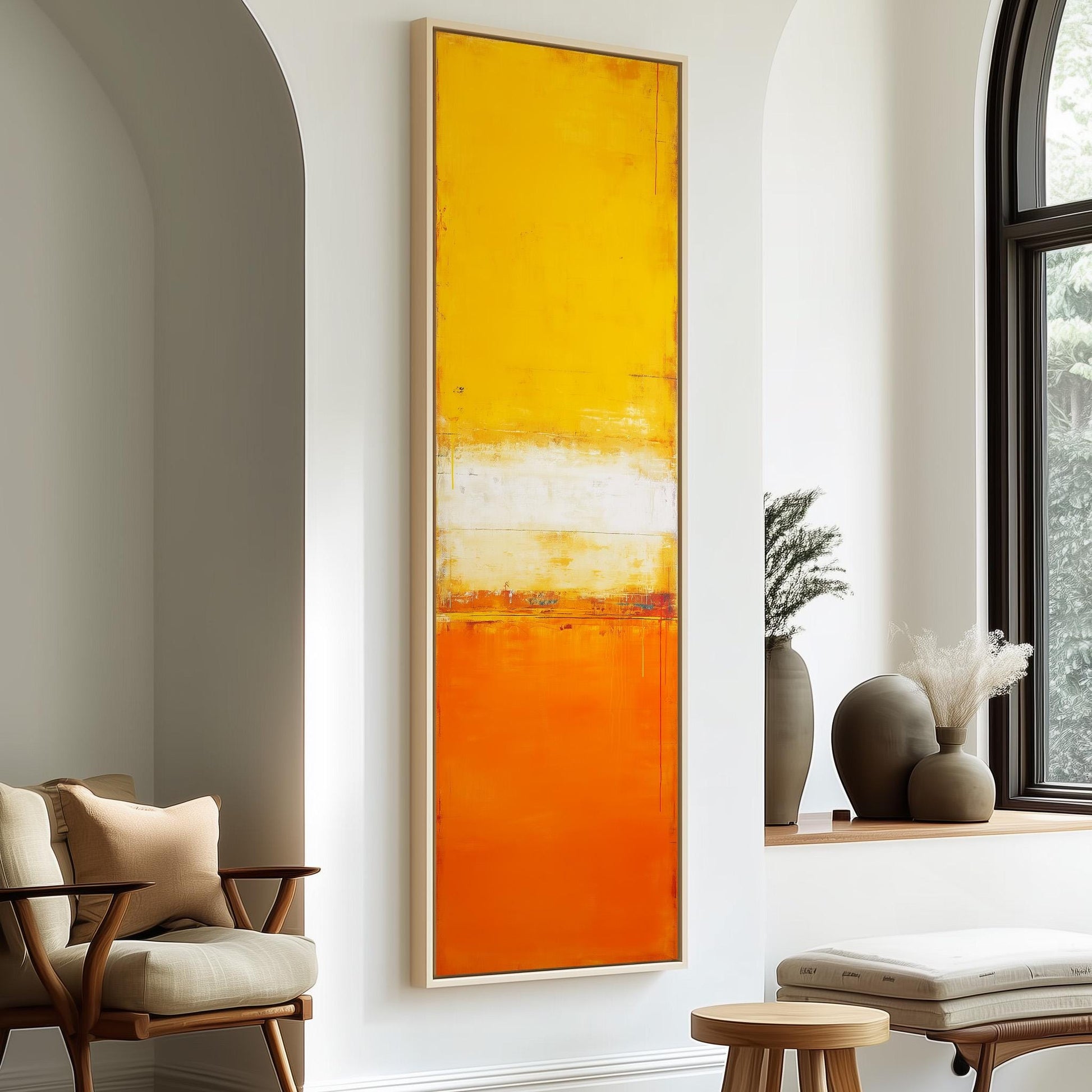 a modern living room with a large abstract painting in warm orange and yellow colors hanging on the wall. The room is furnished with a chair, a table, and a window with a plant on the sill.