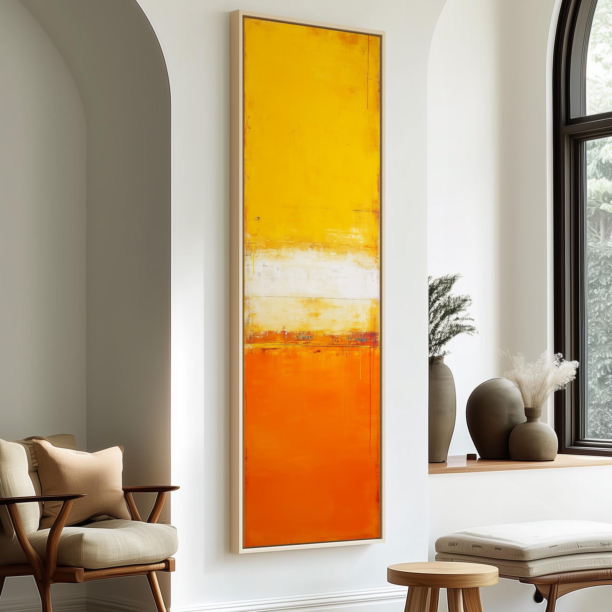 a modern living room with a large abstract painting in warm orange and yellow colors hanging on the wall. The room is furnished with a chair, a table, and a window with a plant on the sill.
